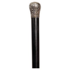 Walking stick with finely embossed silver knob with floral elements, Italy 1900.