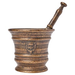 A bronze apothecary mortar with pestle and crowned crest, Italy 18th century.