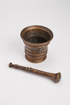 A bronze apothecary mortar with pestle and crowned crest, Italy 18th century.