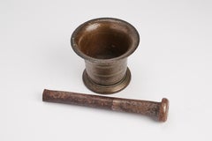 A bronze apothecary mortar with incised lines & iron pestle. Italy 18th century.