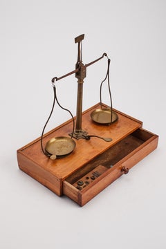 Antique brass travel balance scale with weights on cherry base, France c. 1880.