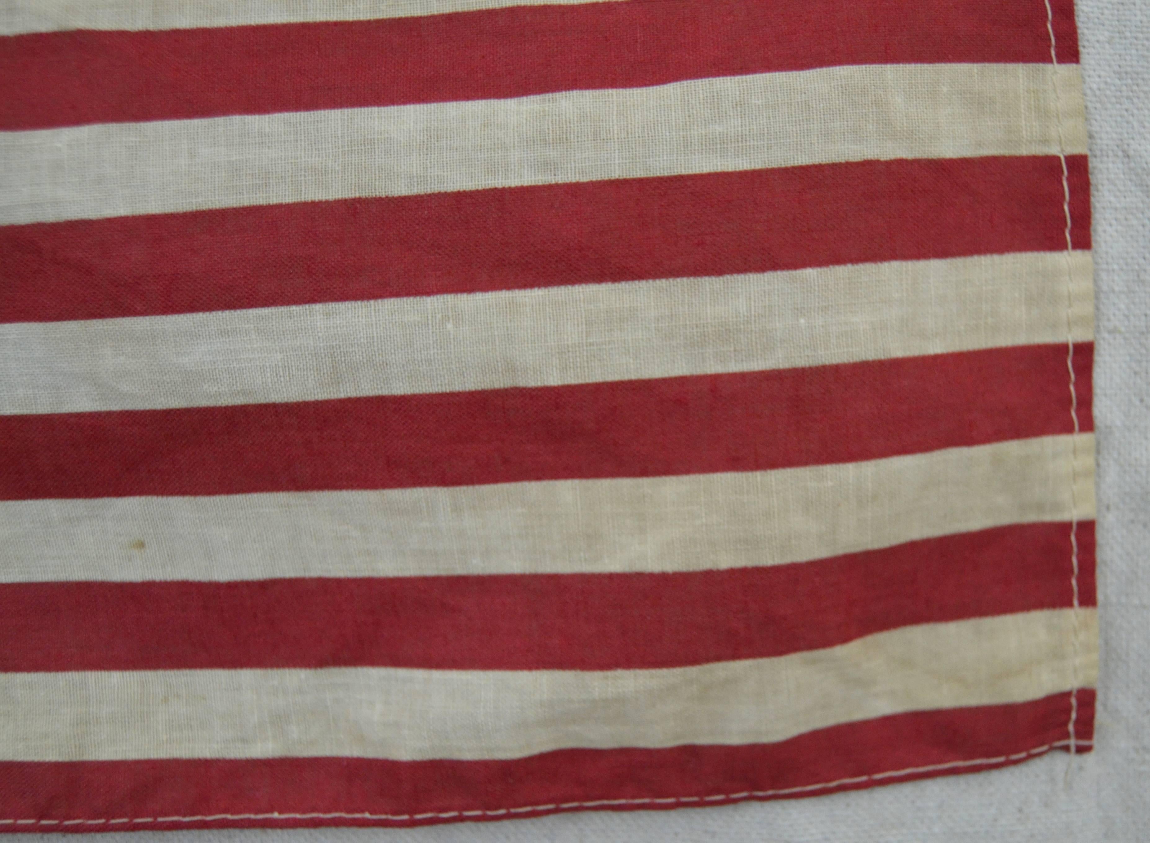 Very graphic and attractive printed cotton flag with sewn edge. 49 star flags were only official for one year when Alaska was admitted to the Union. Nicely sized small example with good overall toning. Unframed.