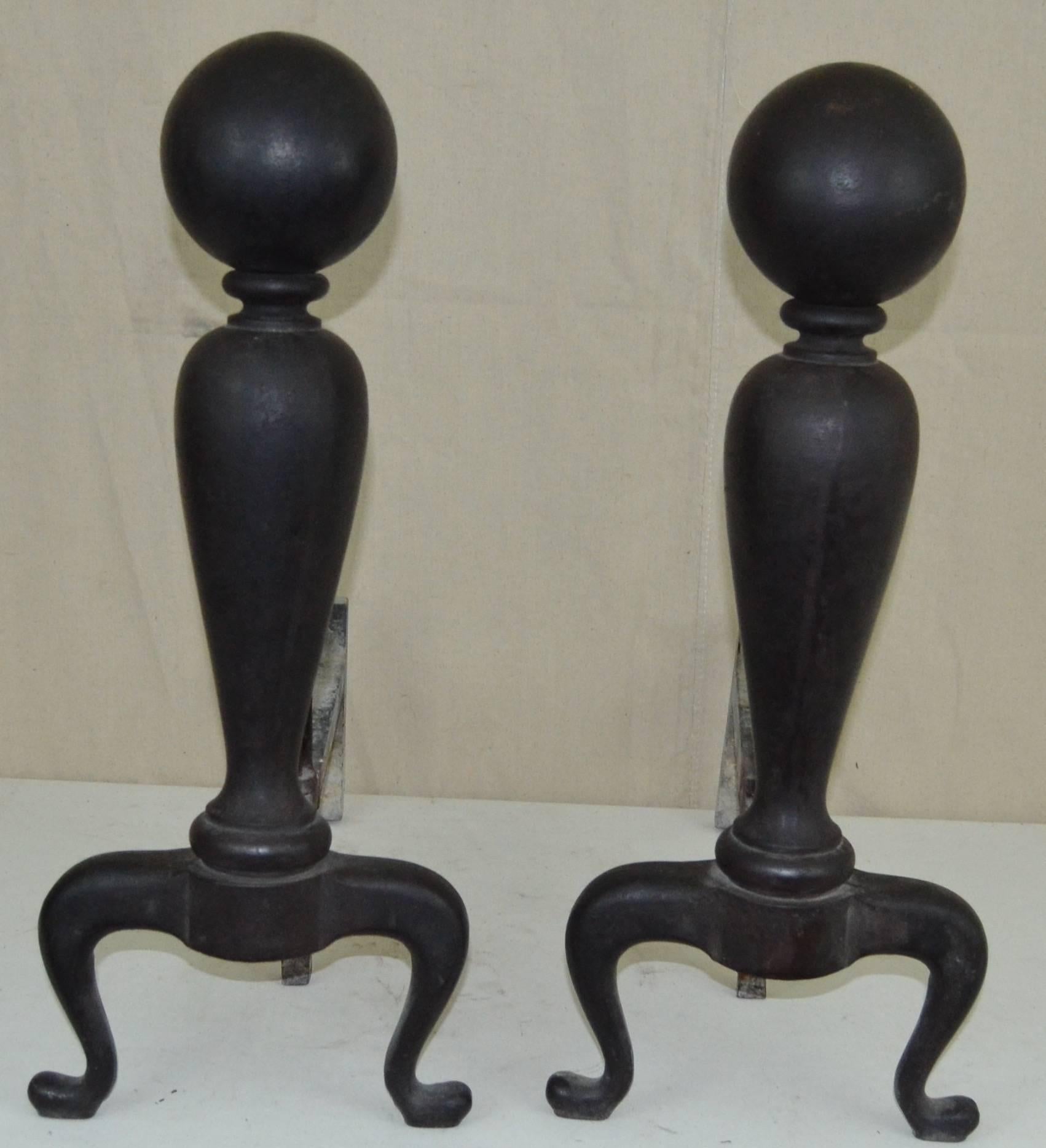 A fantastic set of cast iron andirons, large and very graphic.