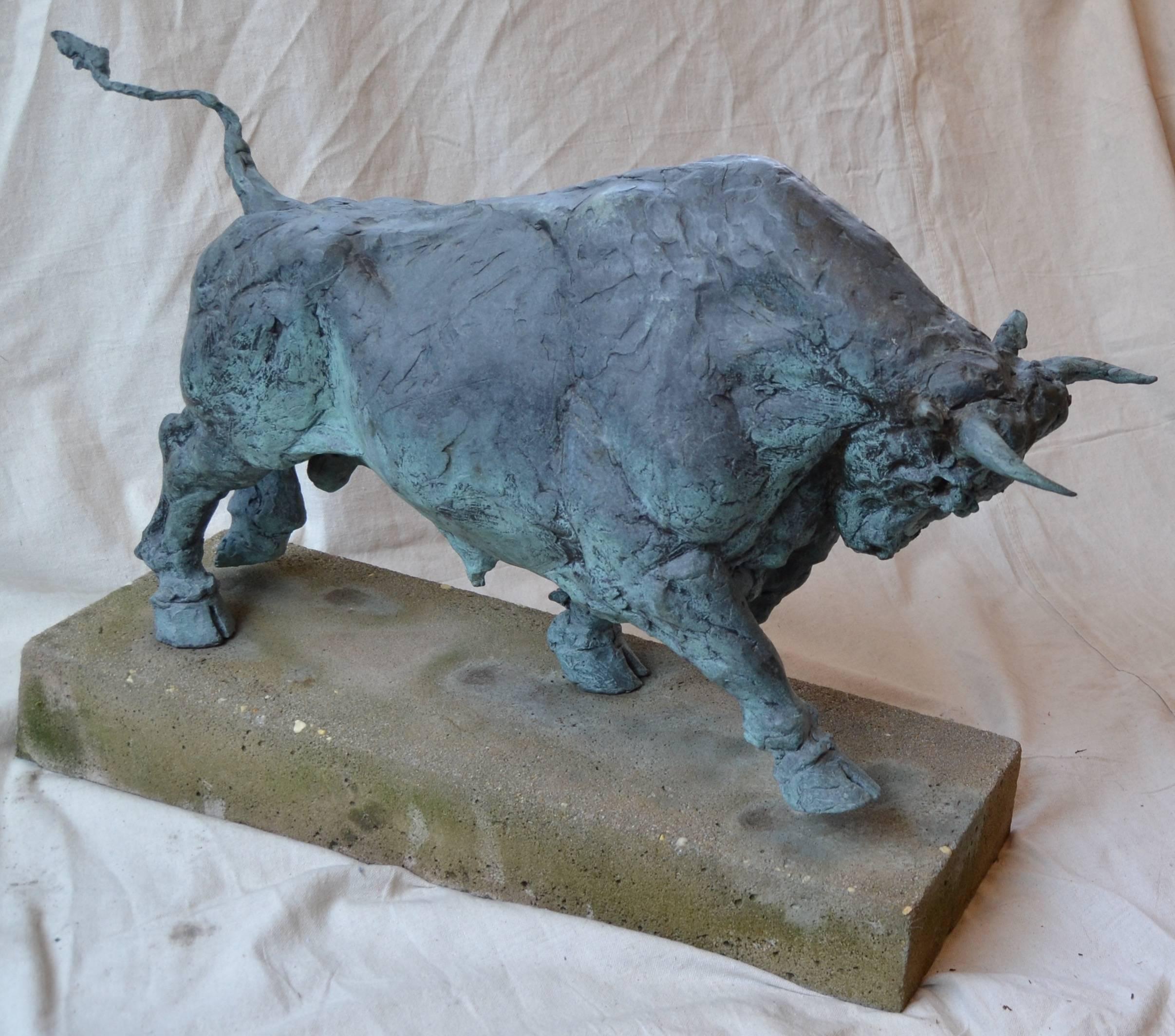 Patinated bronze figure of a charging bull on a cast concrete base. Can be placed in an indoor or outdoor setting. unsigned.