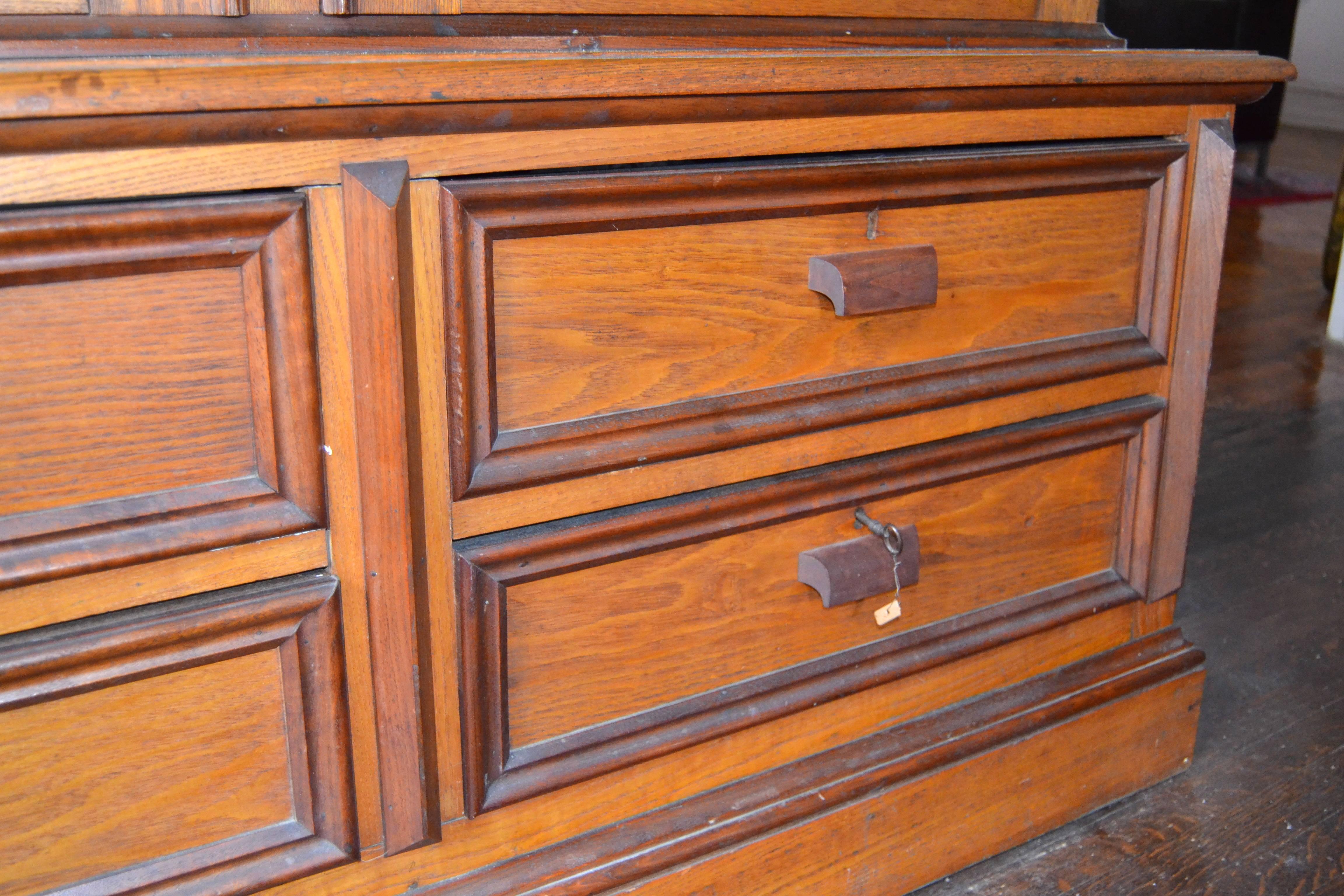 Tall and stately custom built 19th century glazed cabinet with drawers constructed of American Chestnut. Stenciled on the back is 