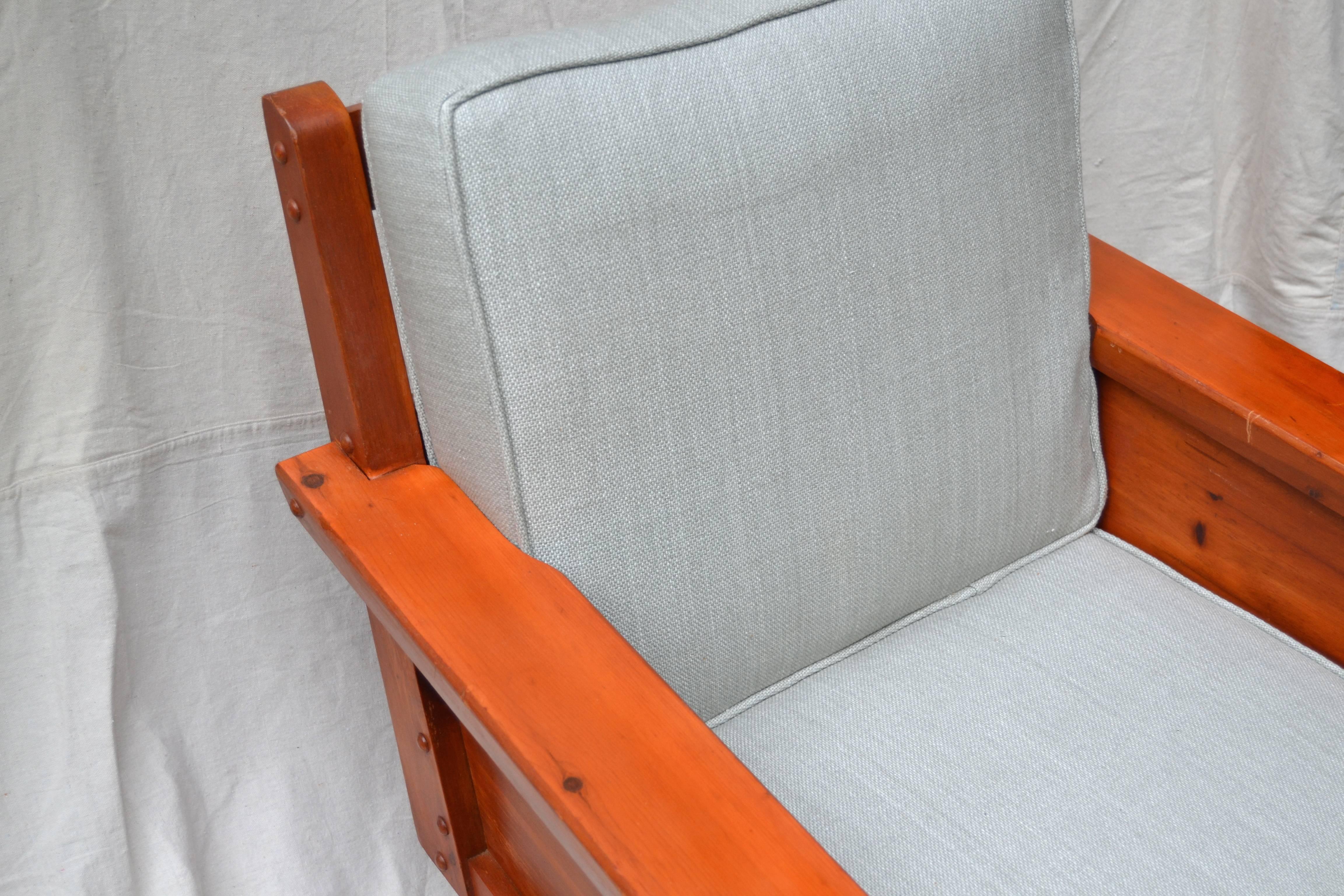 Pair of comfortable and sturdy knotty pine club chairs by the stylish Mid-Century designer and manufacturing firm Habitant Shops of Bay City Michigan. The carefully crafted stained pine chairs have a wonderful casual chic, perfect for the chalet,
