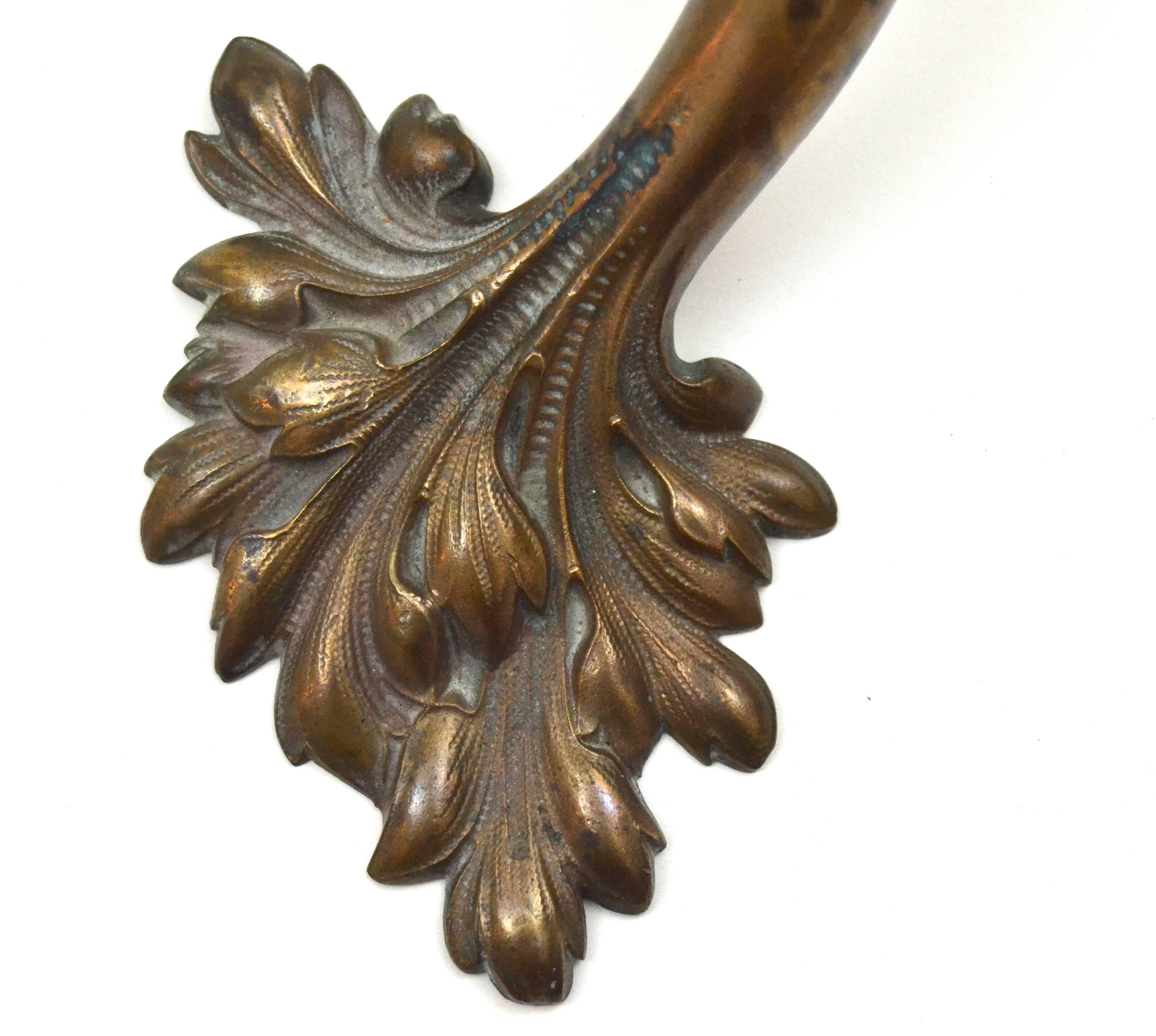 Sinuous leaf form bronze door handle of exceptional patina and casting. Great deep color and gutsy form. The curvaceous handle anchored by the organic forms makes a lovely sculptural statement.