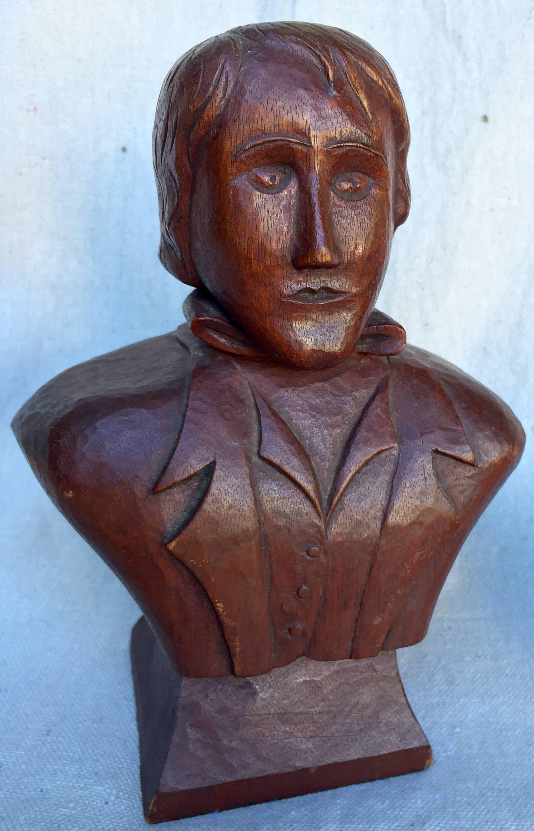 Crisply carved mahogany bust of a handsome young man in waistcoat and jacket and tie. String sculptural presence and interesting detail on this late 19th century, American Folk Art carving.