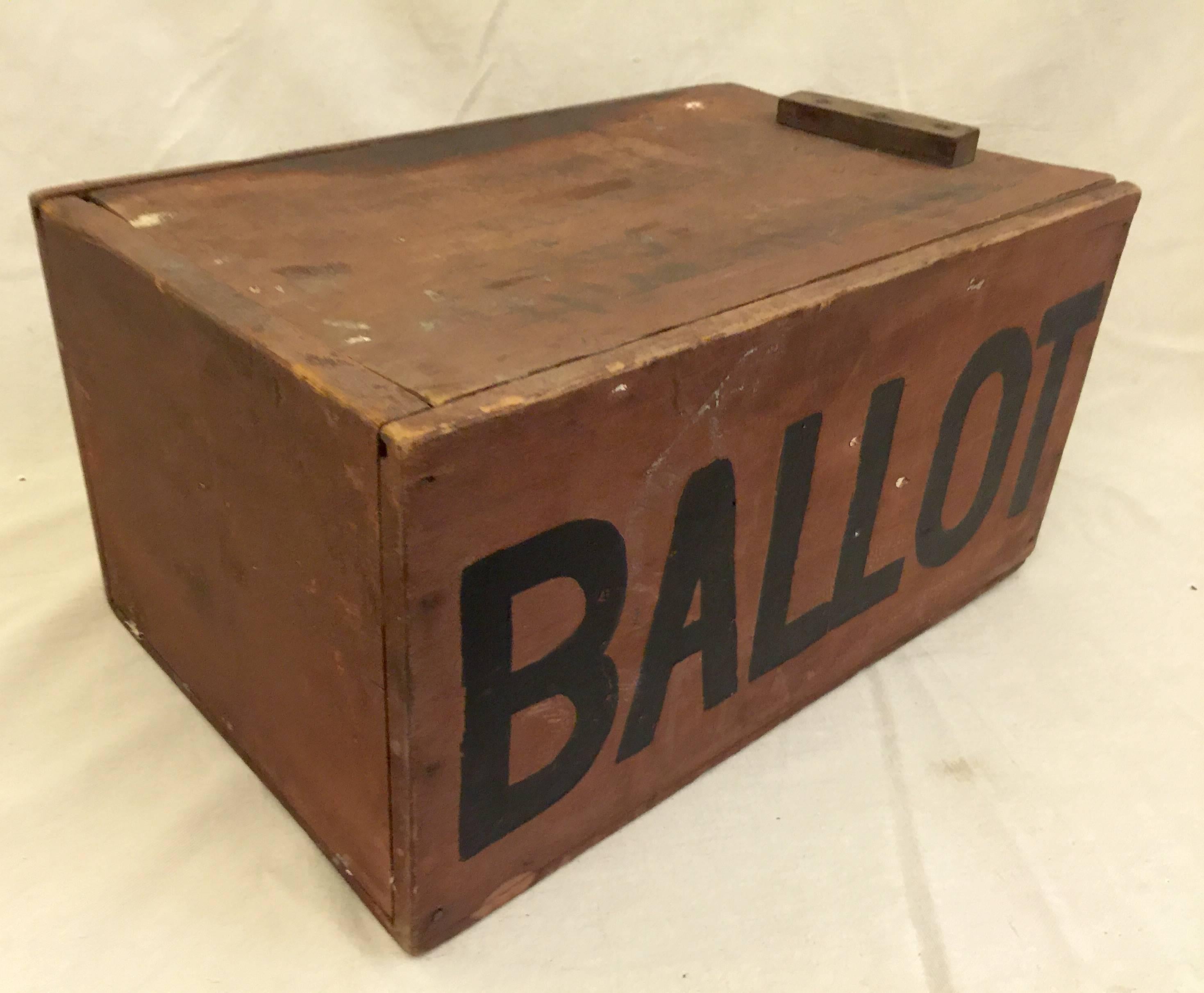 Large red painted slide top box with bold lettering. Faded script on top indicates Maine origin. Original paint and square nail construction. Handle likely added later in the 19th century.