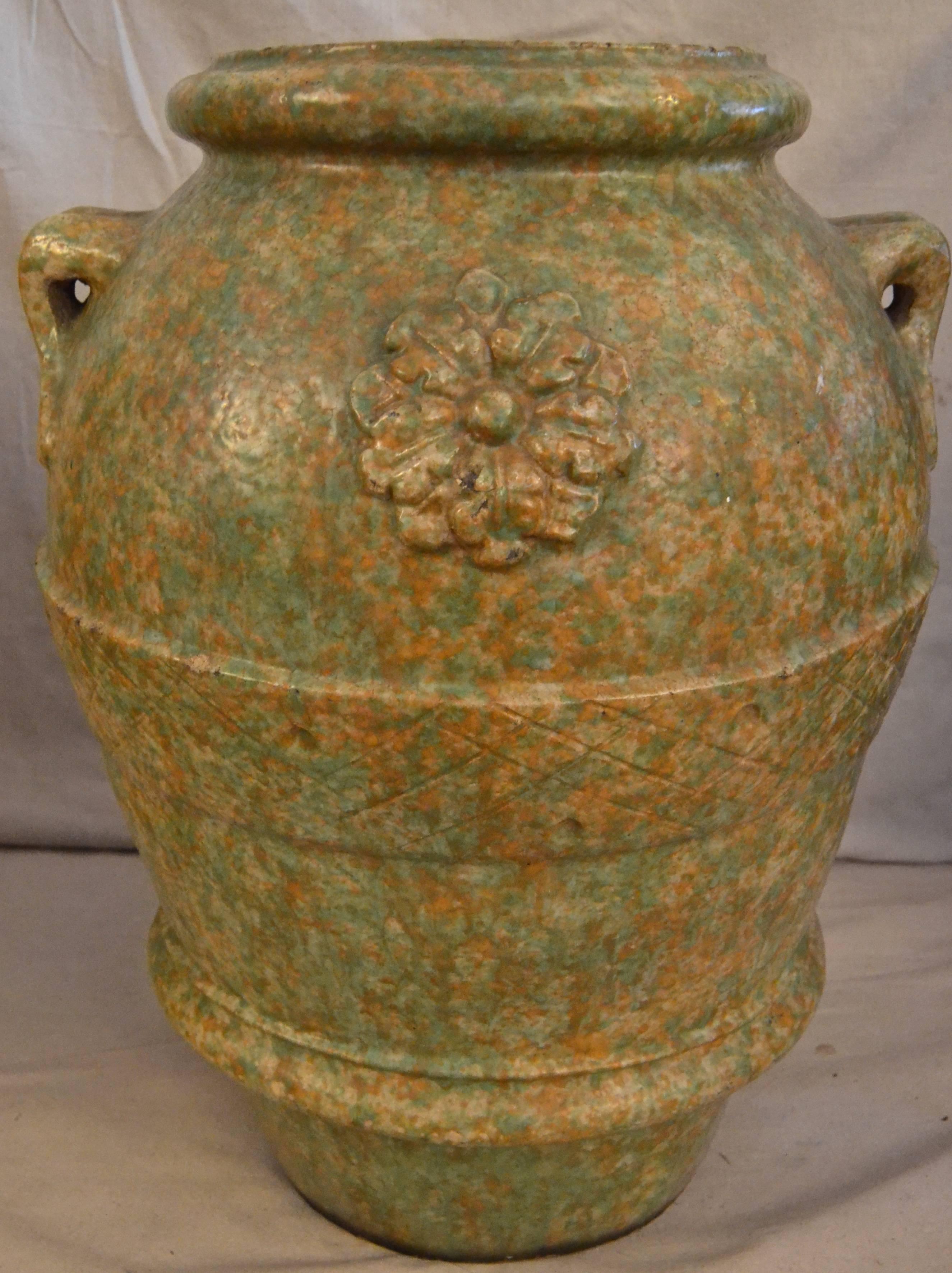 Pair of glazed pottery floor or garden urns from a Philadelphia estate. Wonderfully rich mottled glaze with incised decoration, relief rosettes and applied handles. Unsigned but attributed to Galloway Pottery. Great form, glaze and large-scale make