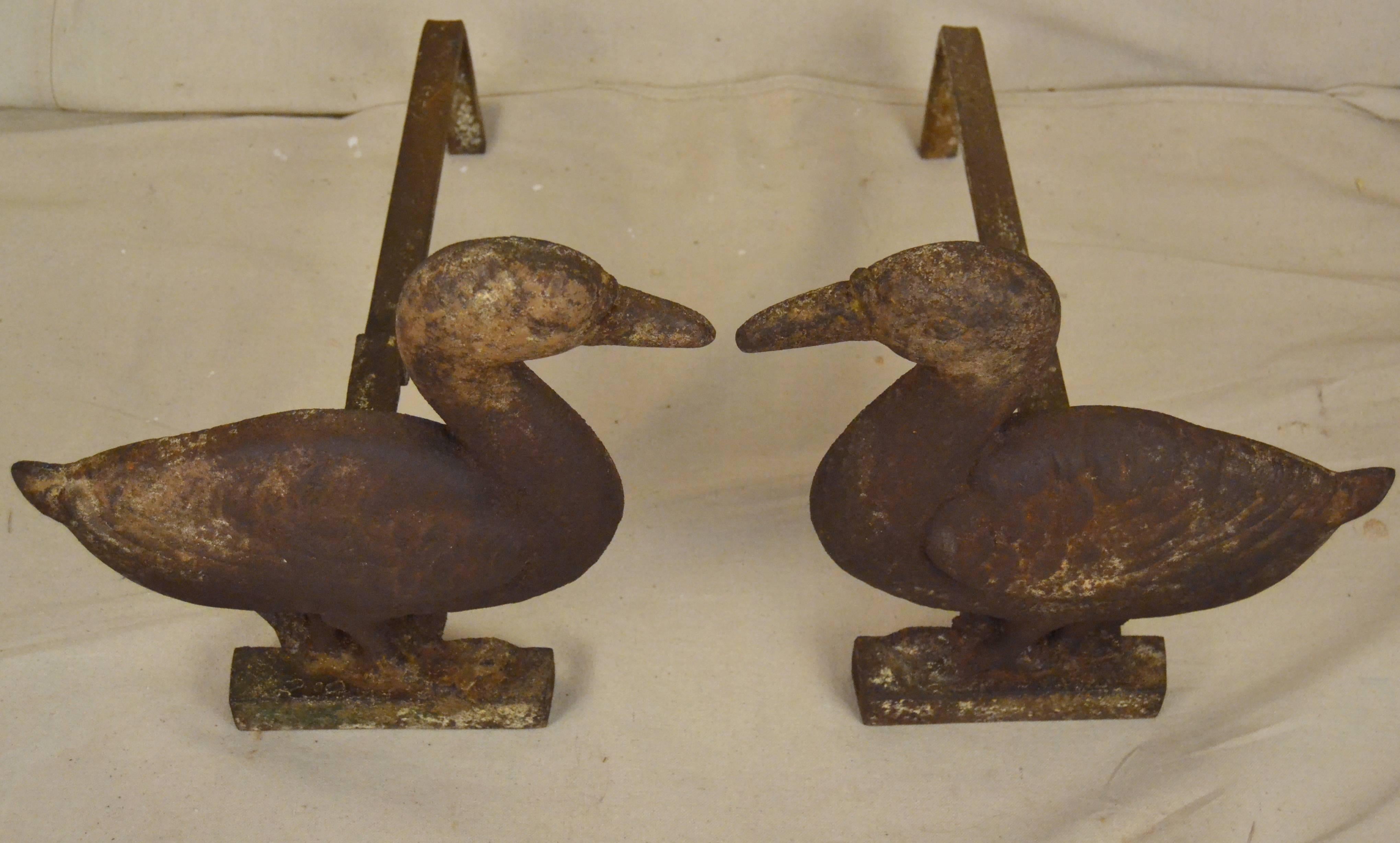 Cast iron andirons depicting a pair of feathered friends. Unusual and rare form we haven't encountered before. It's especially nice to have an opposing pair. Overall attractive rust with remnants of polychrome decoration, circa 1930.