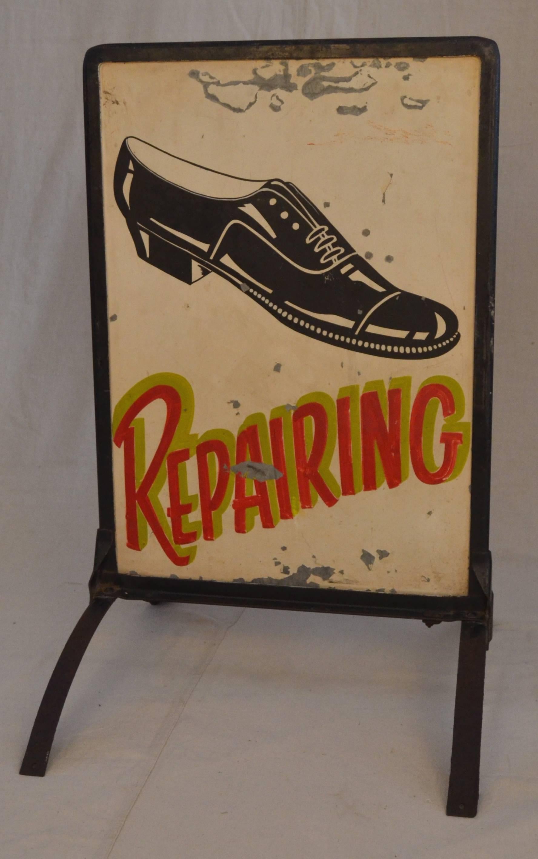Hand-painted standing sign with hand drawn lettering and pictogram shoe for men's shoe repair. Lively and well composed with a dynamic shoe and punchy pop font shadow lettering. Sign painter's signature 