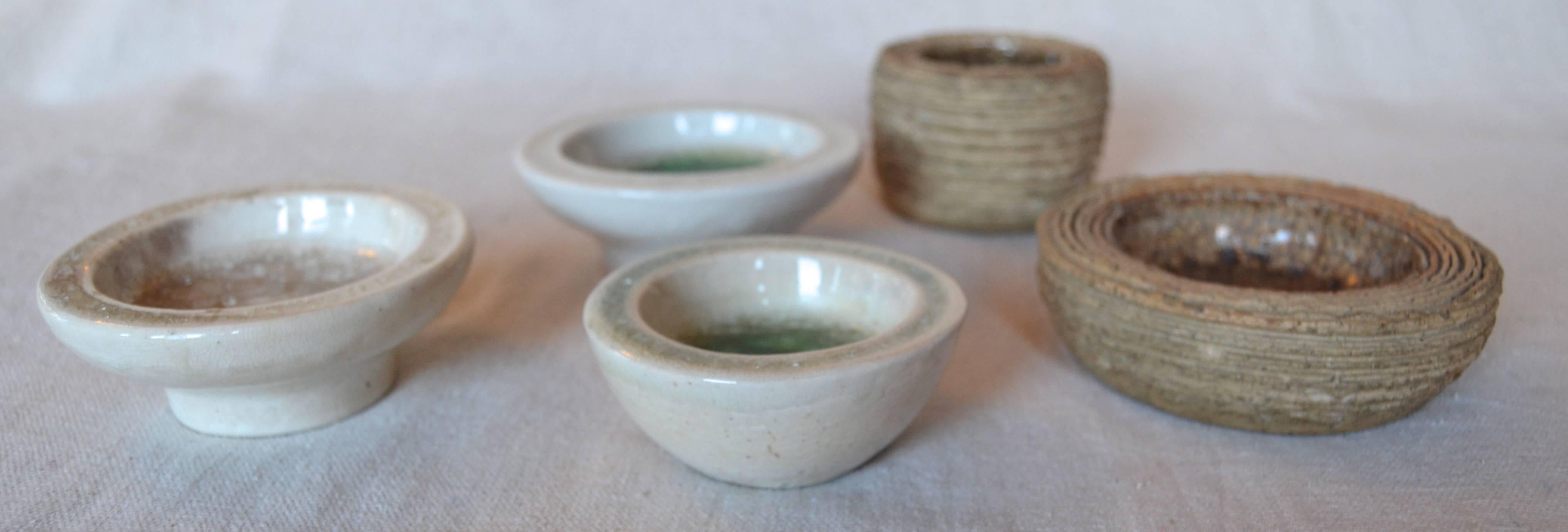 Five small Waylande Gregory bowls, three have the fused glass glaze and two are unglazed stoneware with a metallic glaze interior.
Sizes: All in inches
large unglazed 4.25 x 1.5, small unglazed 3 x 2.12, small fused glass (studio) 3.25 x 1.12,