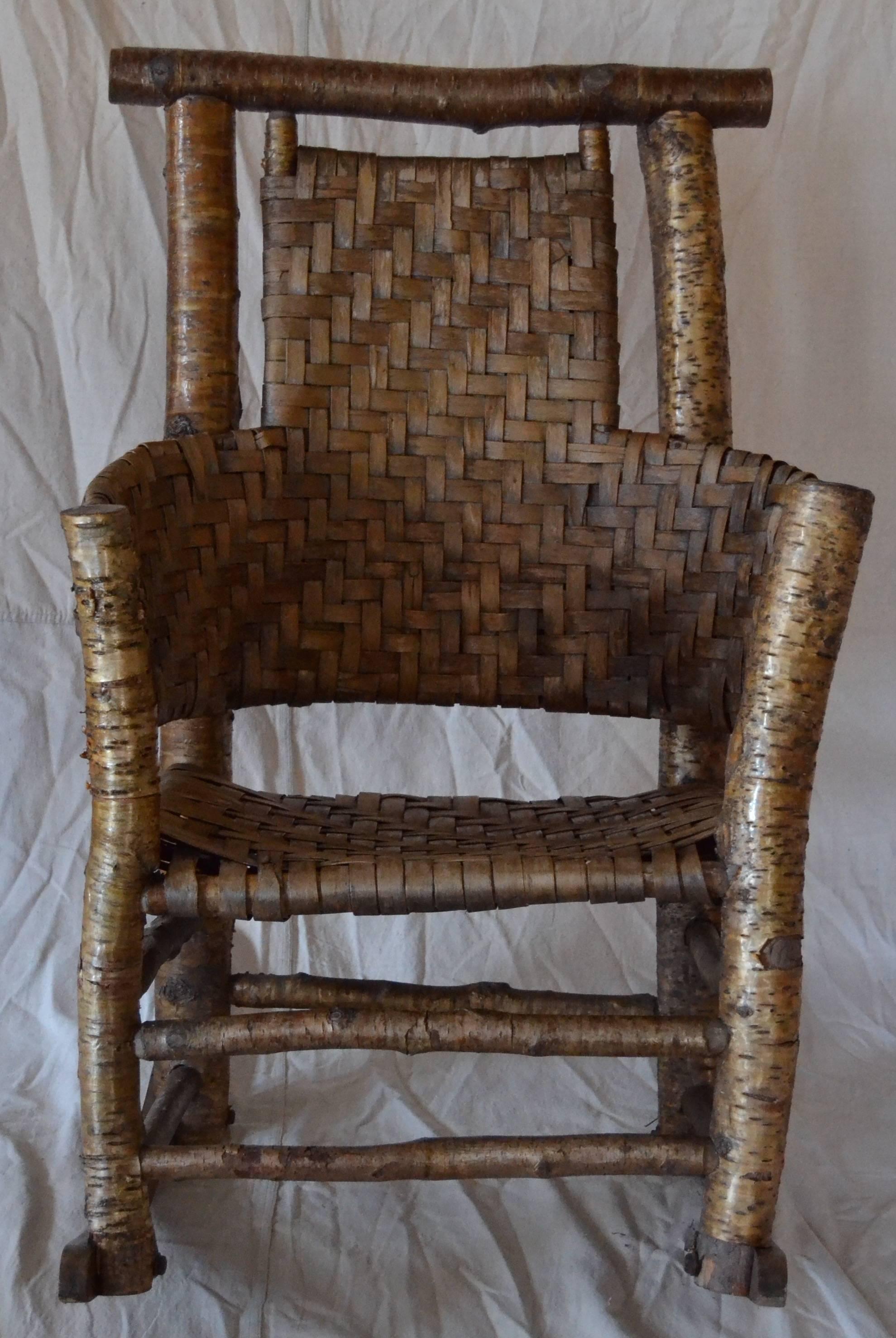 Rare yellow birch rocker by the iconic Adirondack maker Lee Fountain, Wells, NY. Wonderful sculptural form constructed of yellow birch with an ash splint woven seat. Two similar examples of this comfortable rocker are in the Adirondack Museum in