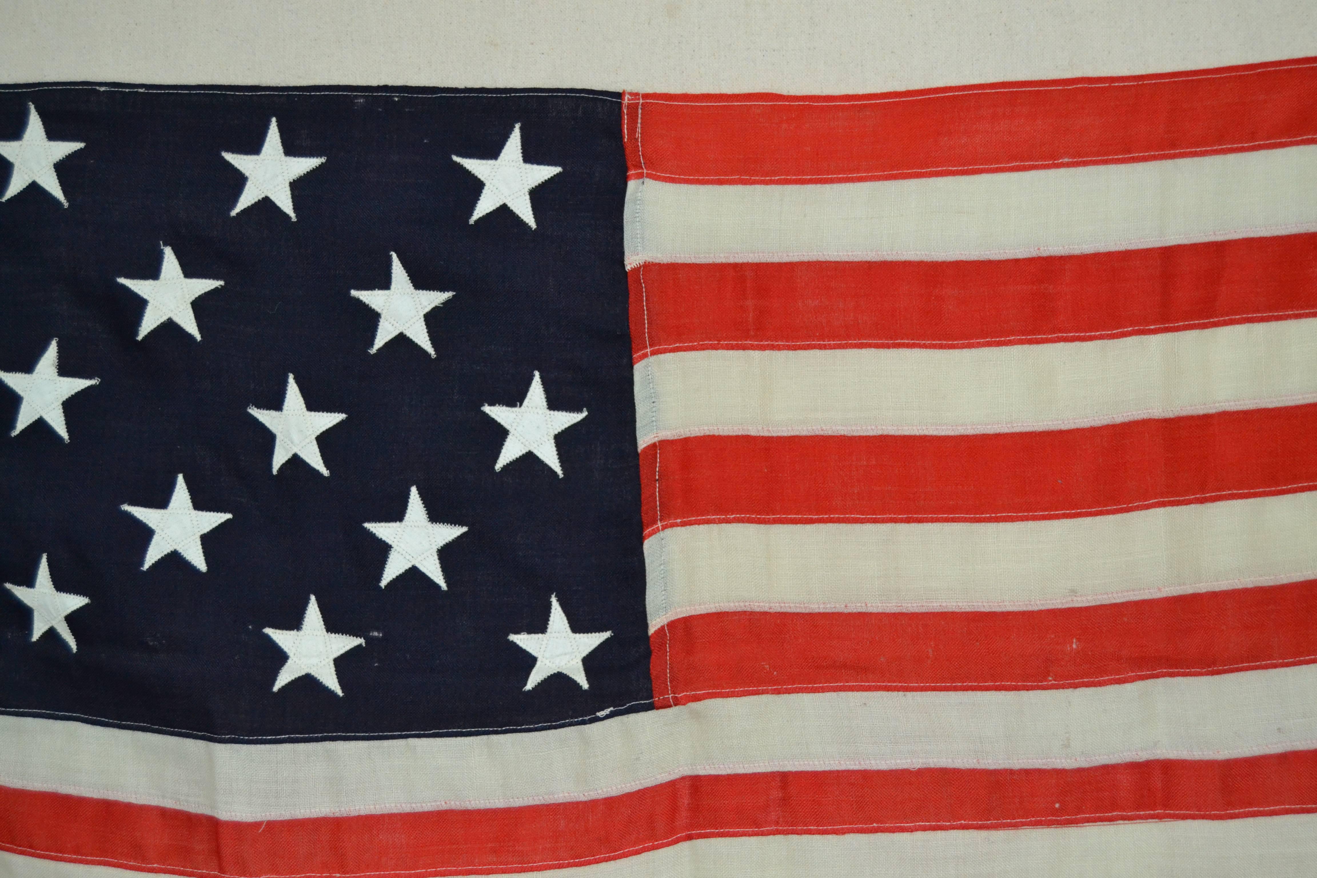 Antique sewn flag from the late 19th or early 20th century with the stars arranged in rows or 3-2-3-2-3 stars, a pattern often seen during this period. The canton and stripes are of wool bunting with double-appliqued cotton stars and a heavy cotton