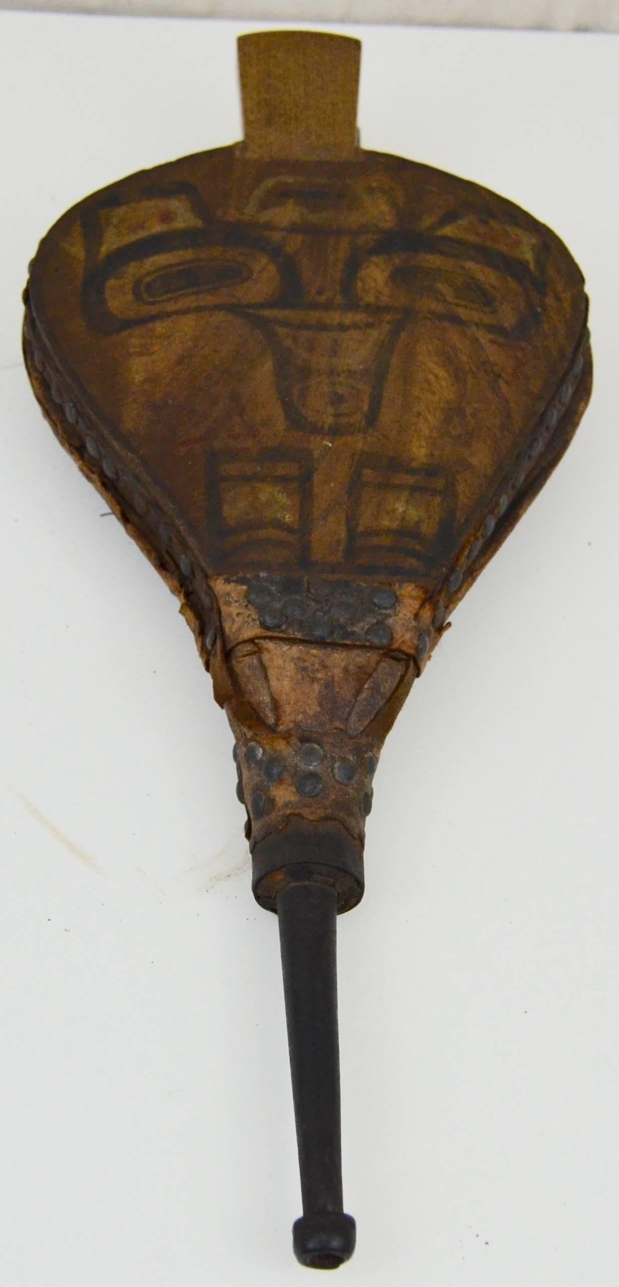 Pair of bellows with images of a bear on on side and a shaman on the other. Used as a part of a whistle. Most likely from the Charlotte Islands.