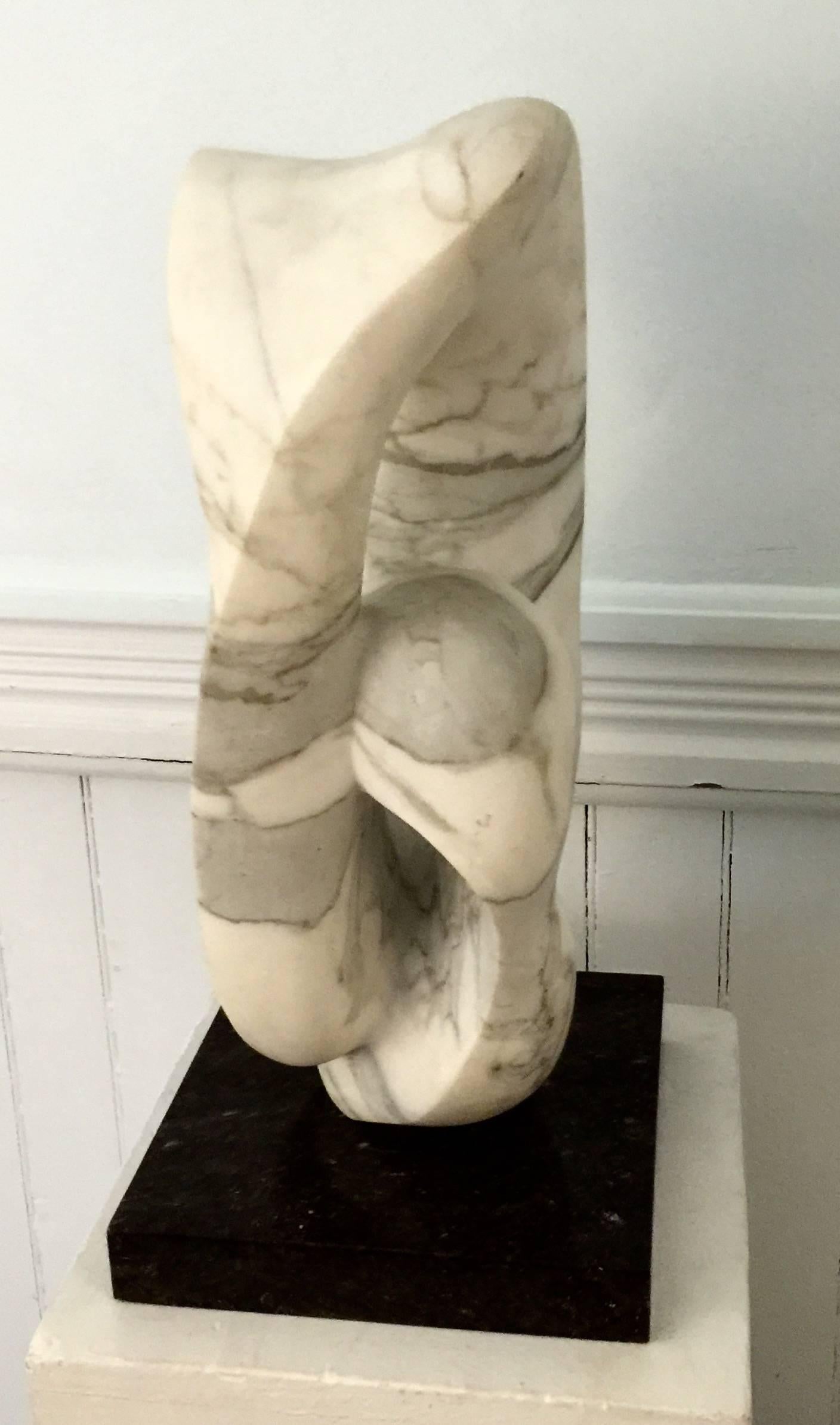 Abstract white marble sculpture on black marble base. Strong forms and stately presence.  Unsigned but attributed to Etienne Hadju a Hungarian born French Sculptor.