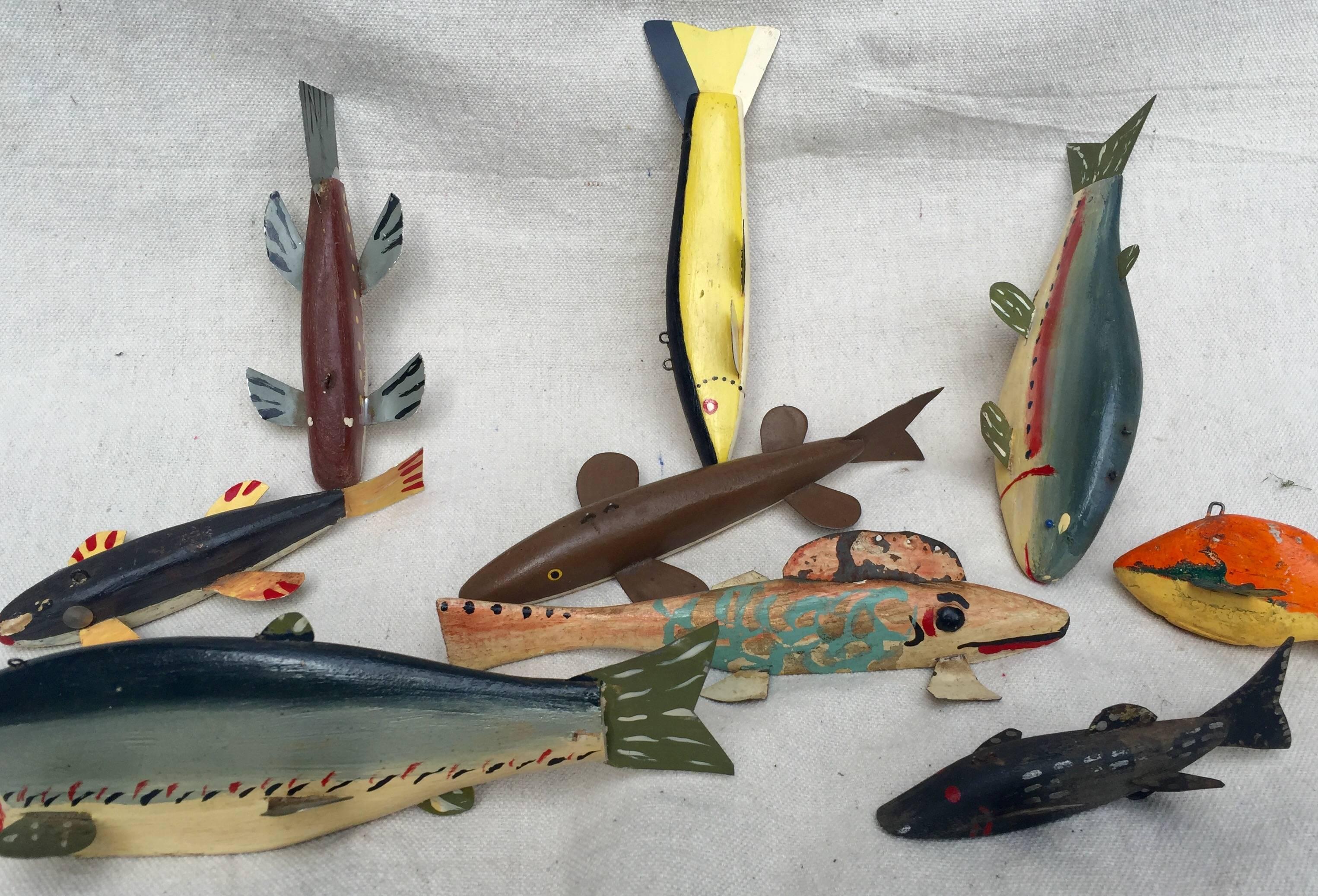 Collection of nine authentic, working ice fishing decoys from the Midwest. Whimsical forms of painted wood with added metal elements. From 3.5