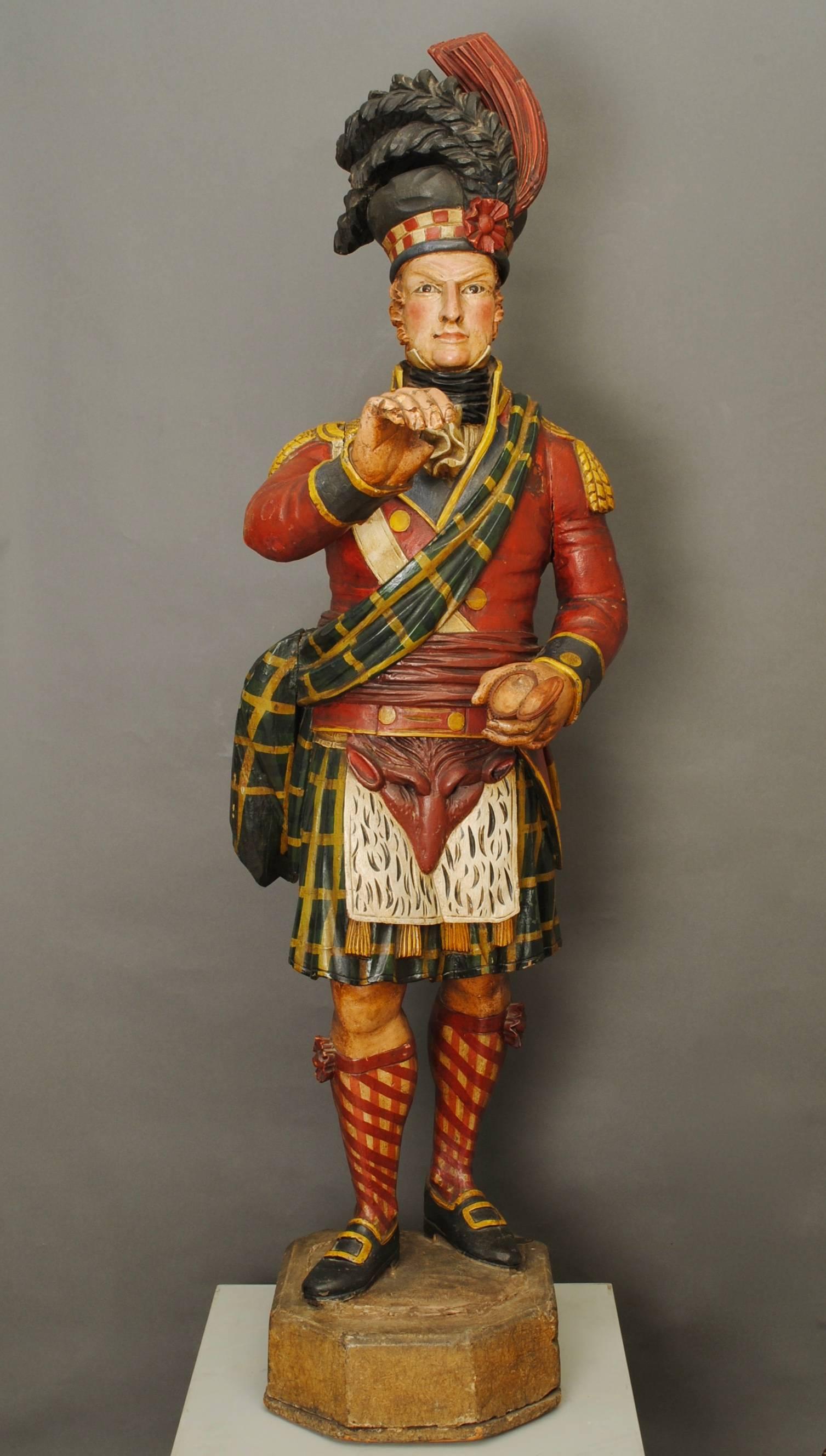 A wonderful example of a 19th century Scottish highlander tobacconists figure in full dress uniform, retaining the original painted polychromed decoration and with glass eyes. Provenance, The imperial tobacco company private museum with metal