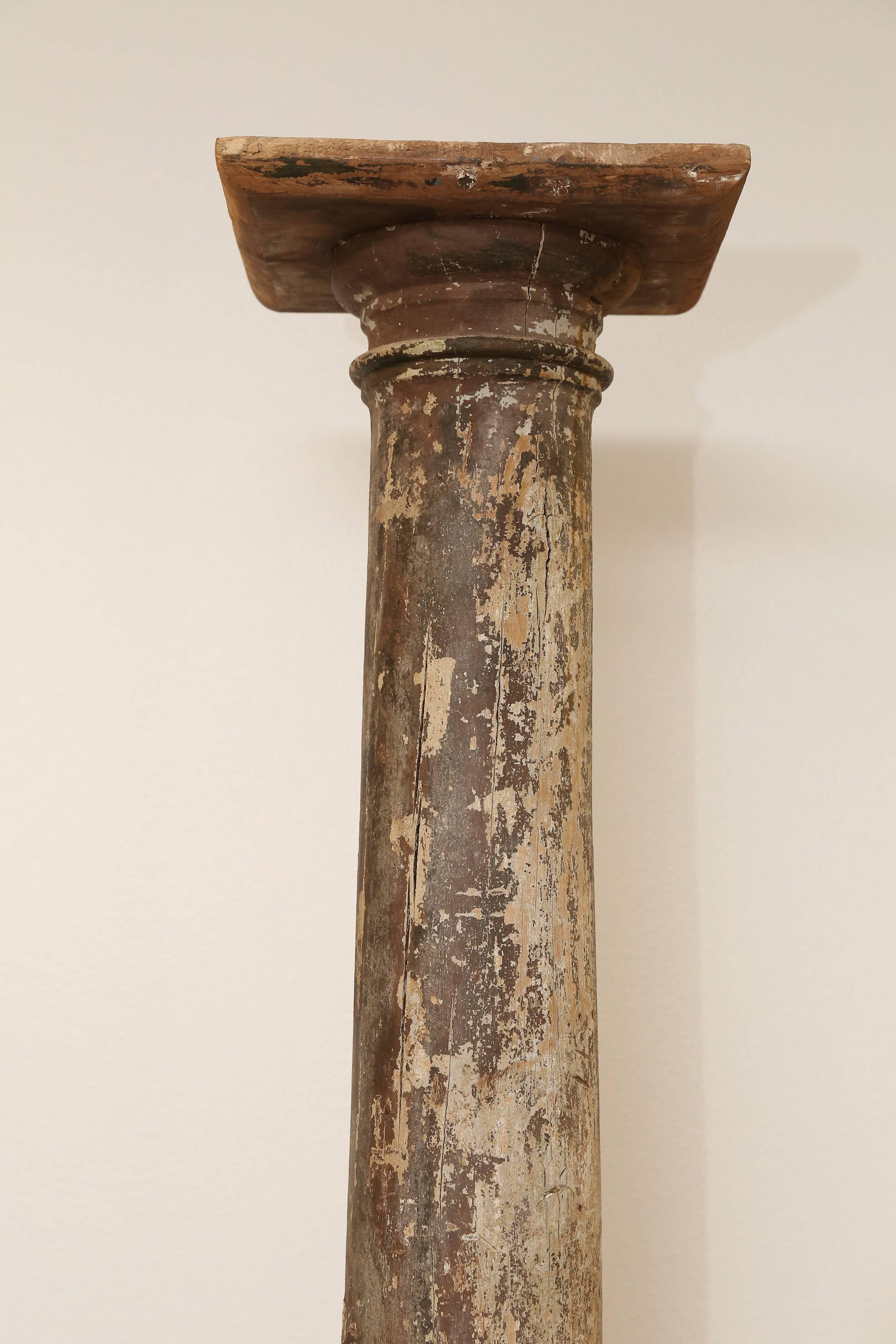 Patinated 19th century column with layers of paint. Base is 14 inches by 14 inches.