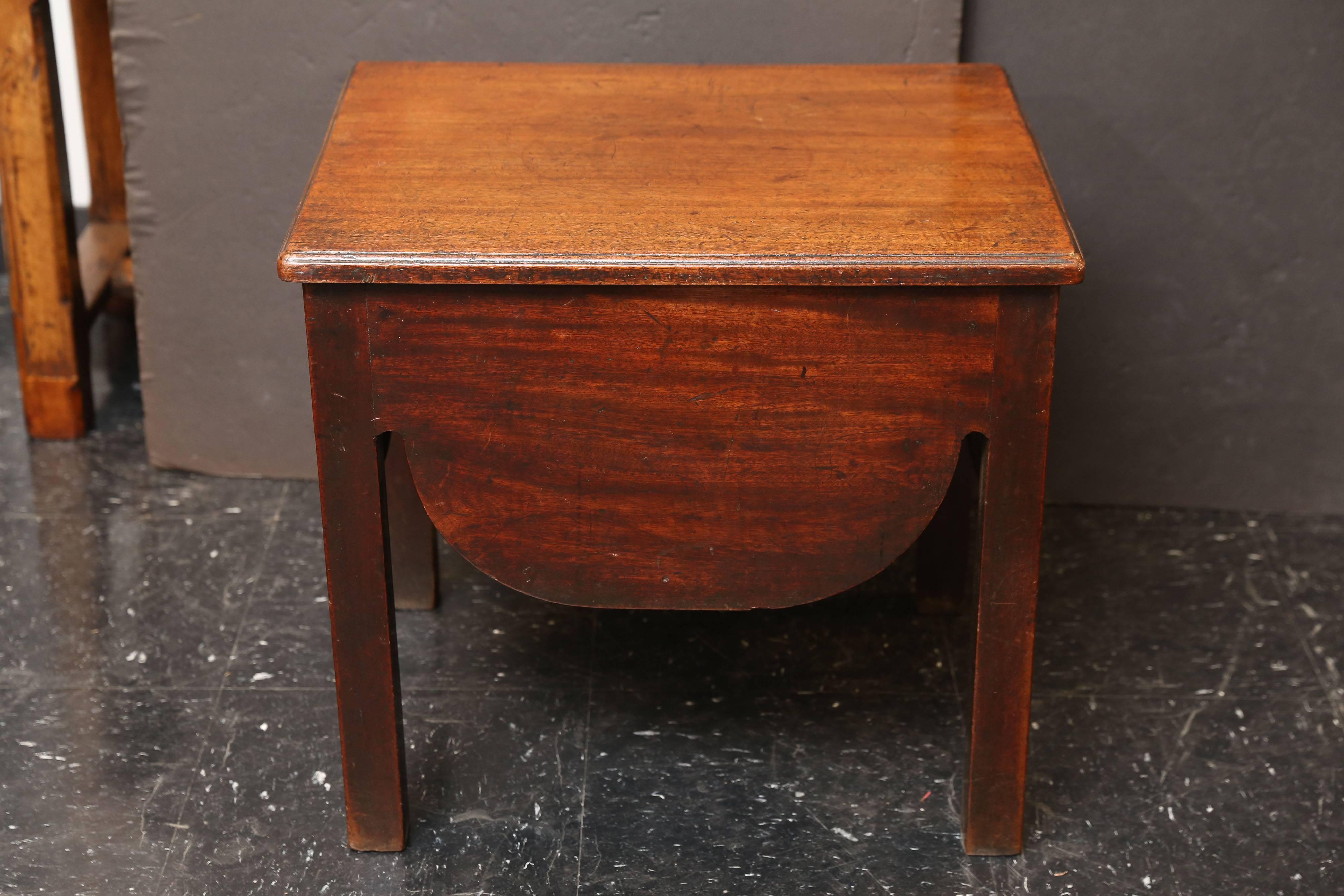 19th century small mahogany side table. Started life holding a chamber pot and has been converted to a small side table with a shaped apron on all four sides.