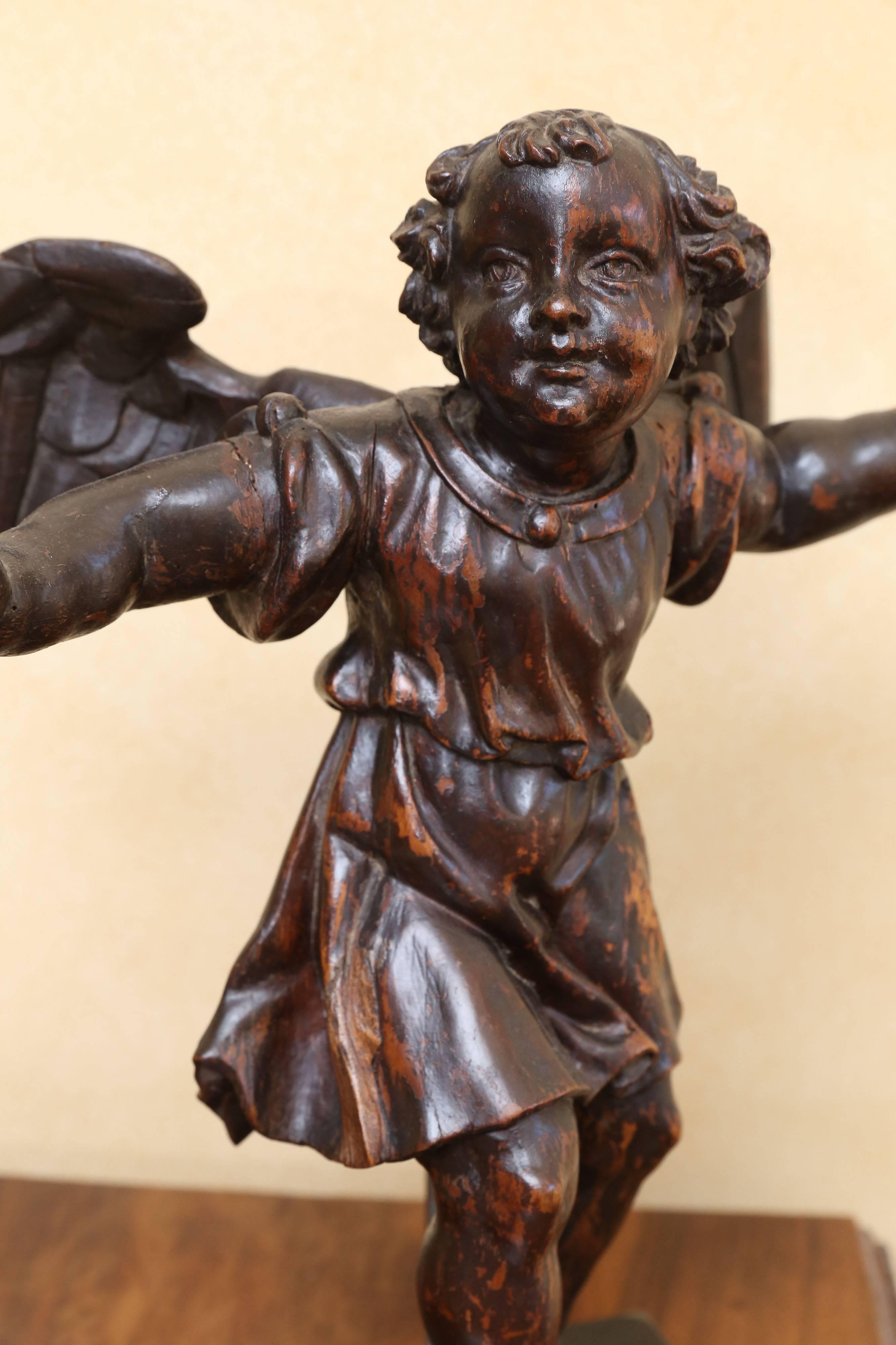 18th century carved angel found in Belgium. Custom stand so that it appears to be dancing.