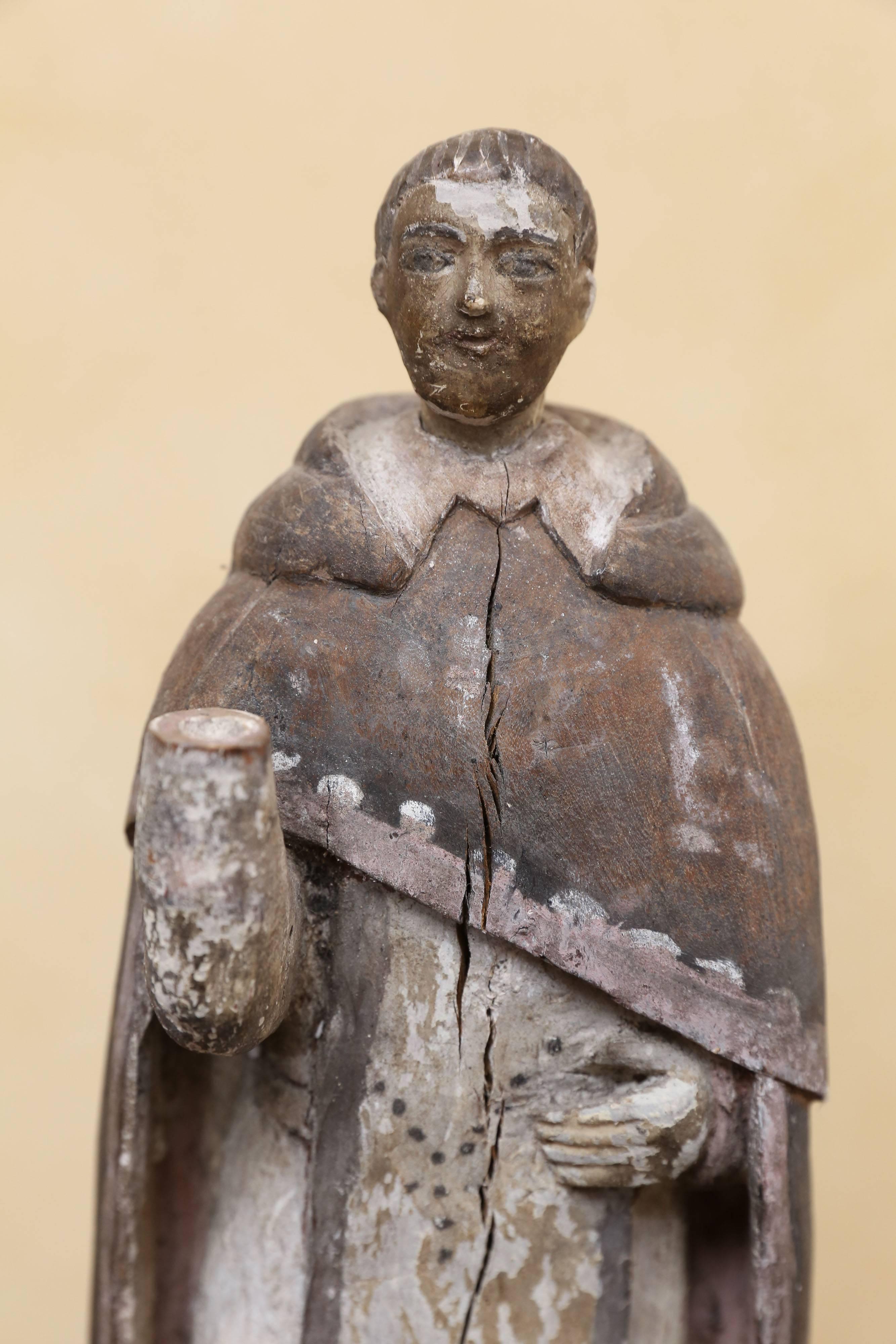Beautifully carved and painted polychromatic religious figure that resembles St. Francis. Right hand is missing. Figure is bearded and is wearing a monk's cloak. St. Francis is the founder of the Franciscan order. He was born at Assisi, in central