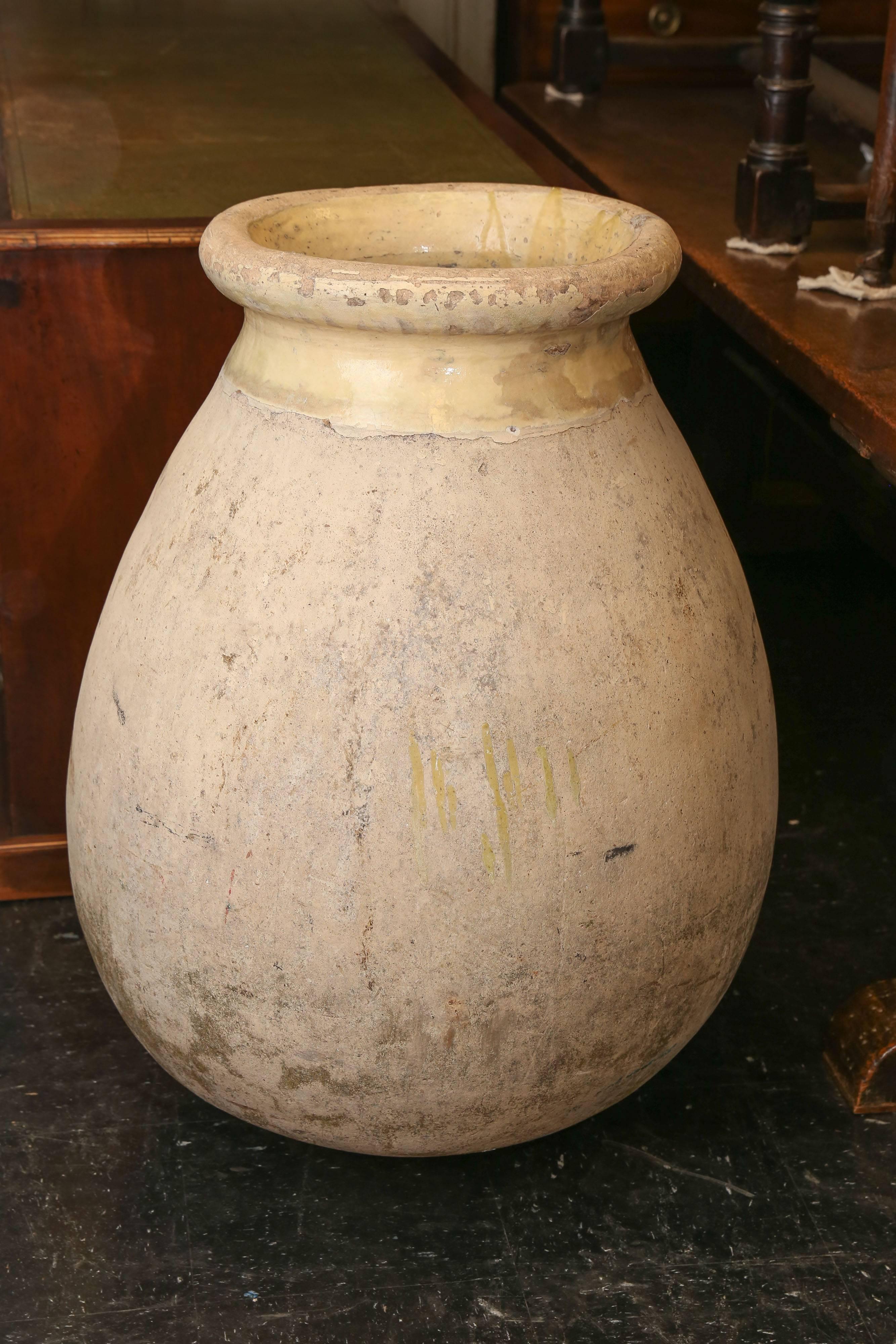 Large 18th century Biot jar with light yellow glaze at rim of opening and inside. These were used to transport olives by ship to the French colonies throughout the world. Opening diameter is 18 inches wide.