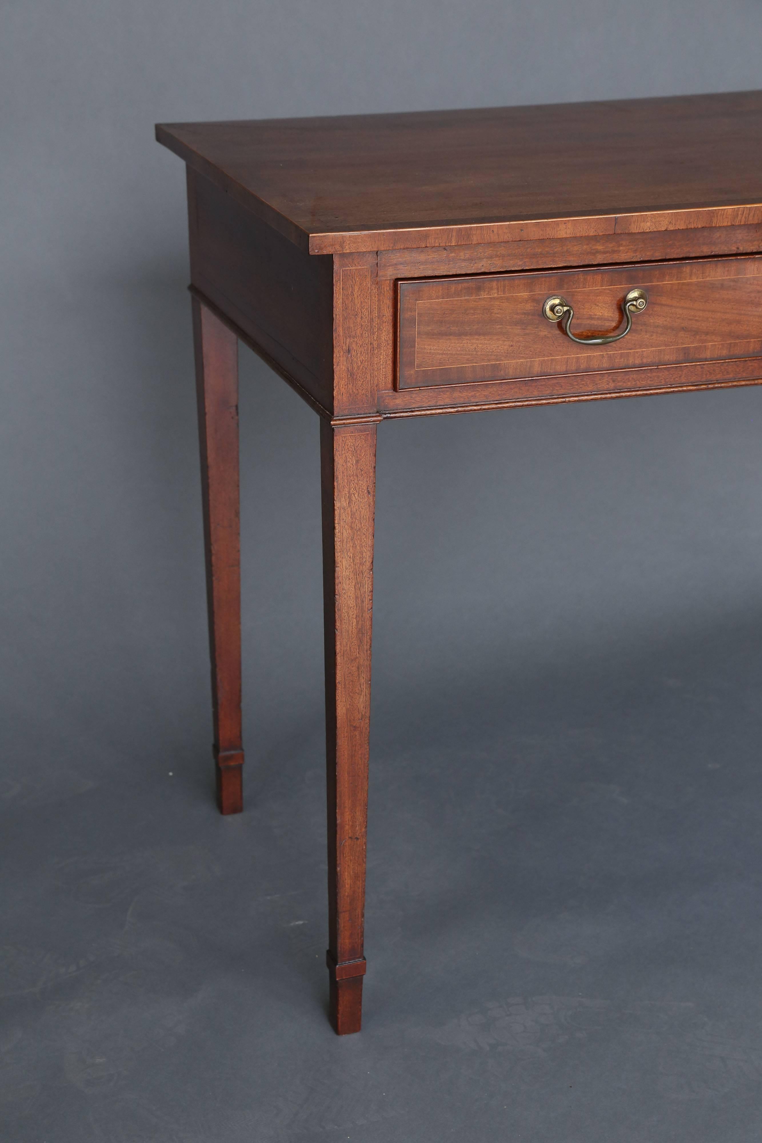 George III mahogany and crossbanded mahogany three-drawer server of excellent color raised on tapered legs with original swan neck brass.