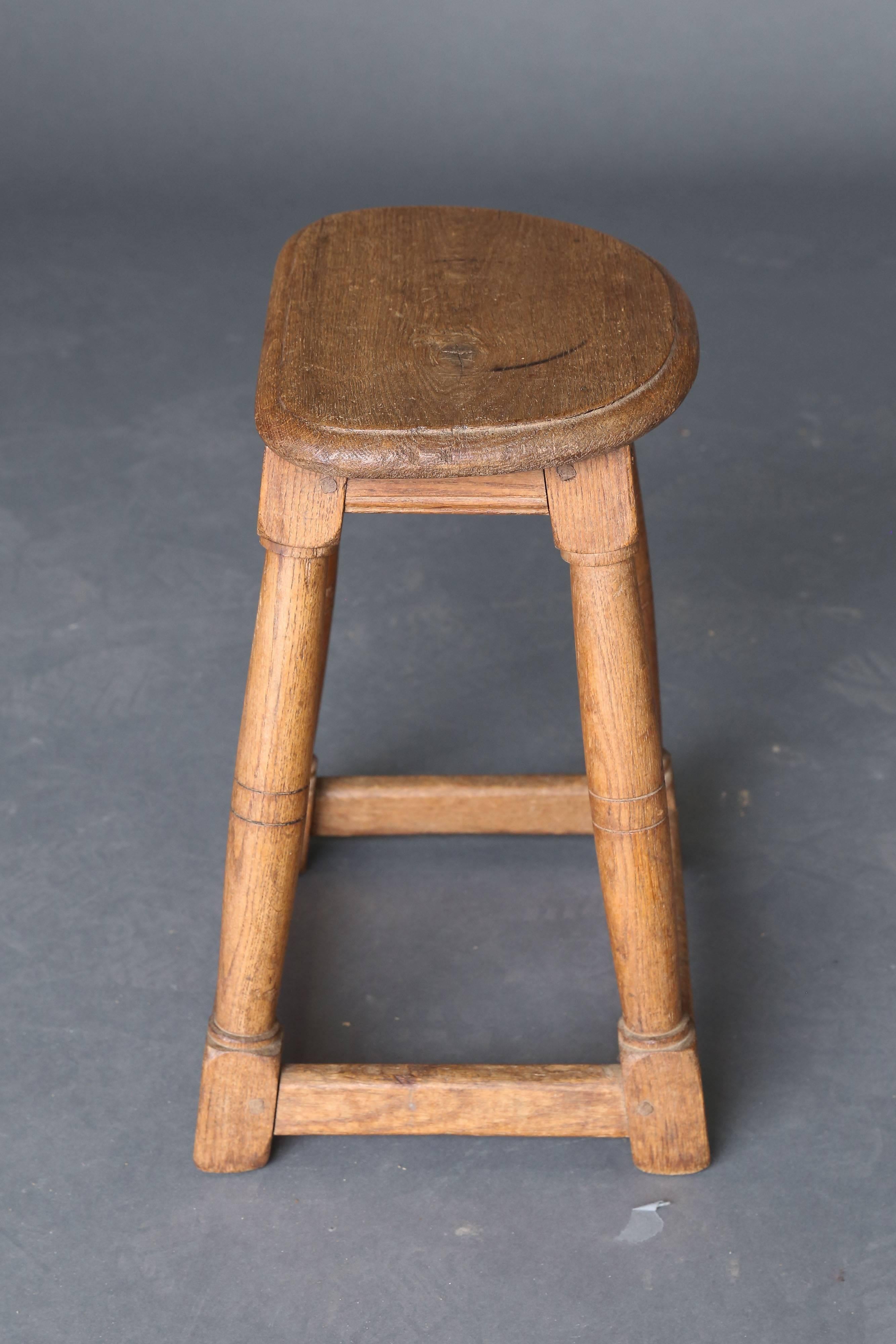 19th century oak stool with stretcher base supporting all four legs.
 