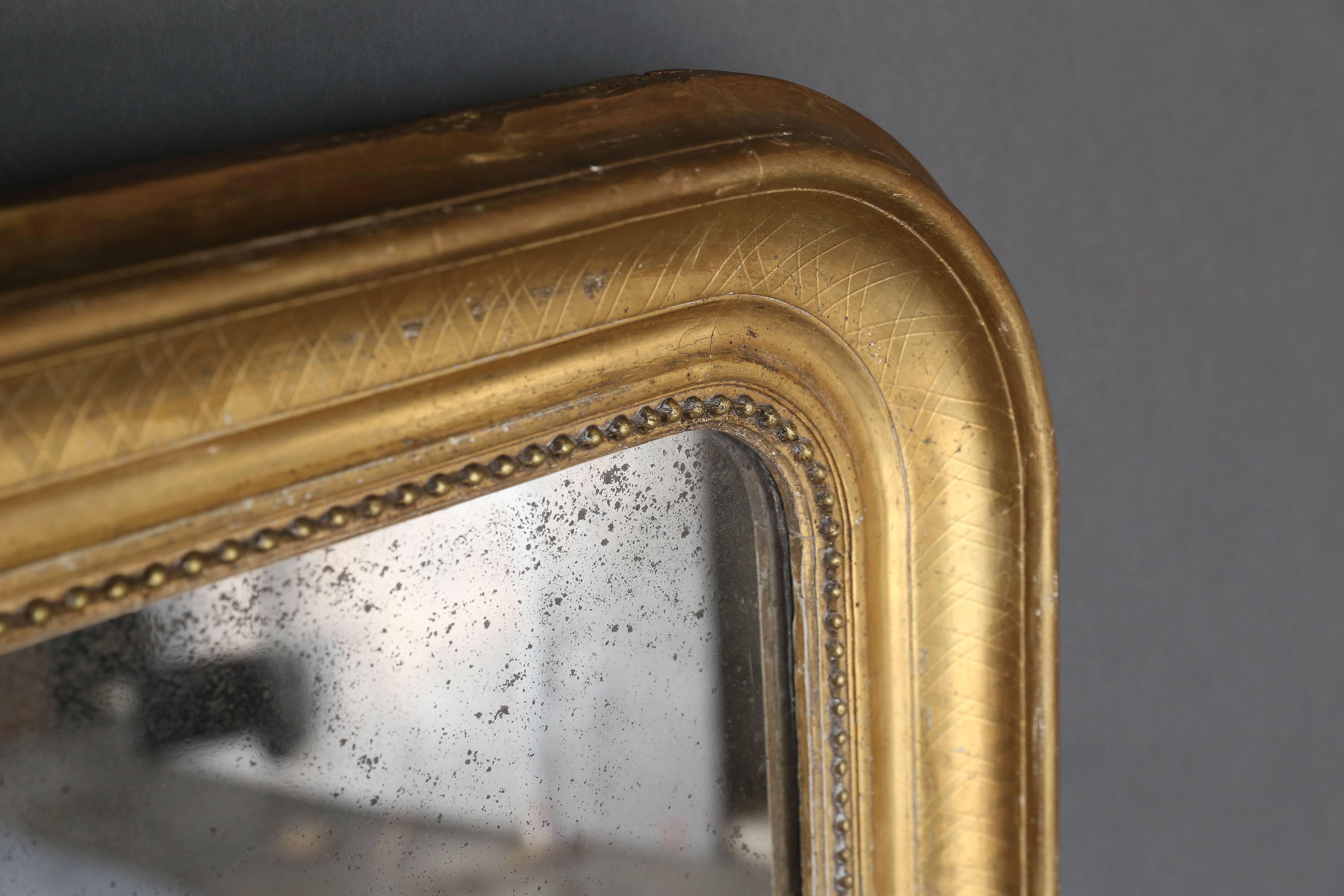 19th century Louis Philippe gilt mirror with original Mercury glass mirror.