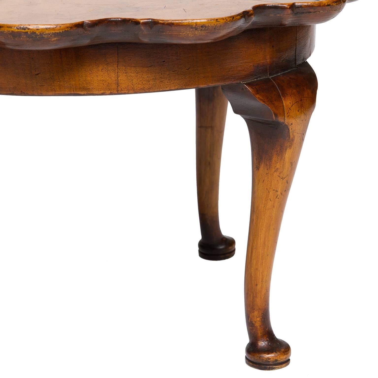 A lovely petite pie crust table made from walnut. Nice faded legs. Bookmatched figured walnut top,(some wear to the top), kind of neat look though. Can be blended easily with wax. The table scalloped design with raised walnut moldings. The top is