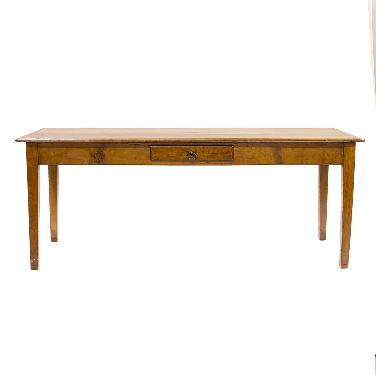 A simple but sturdy French country elmwood farm table. Nice tapered legs leading to an apron having a drawer. A beautiful choice of grained elmwood selected as the top. A mix of colors developed through time, makes it a pleasure to see everyday. A