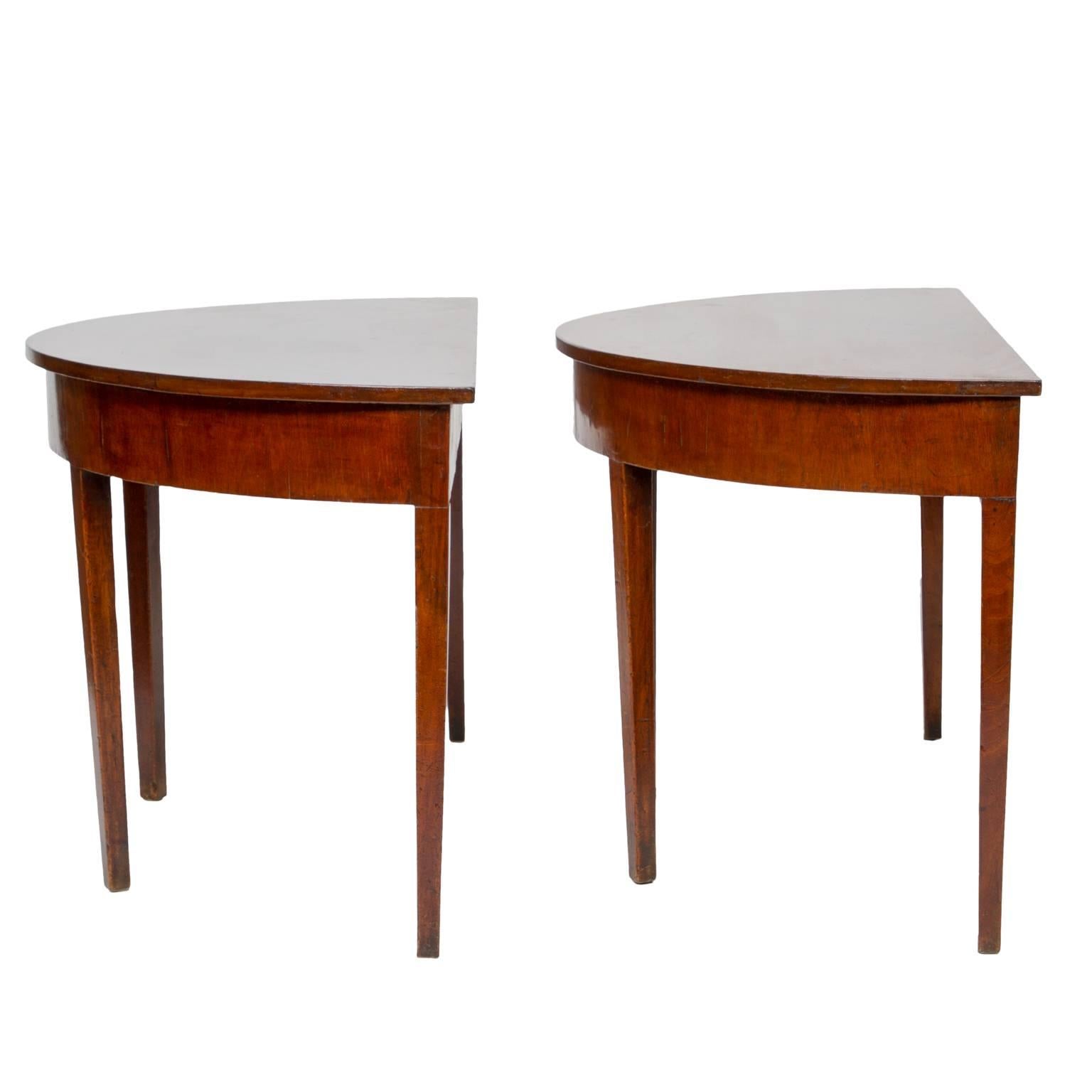 19th century pair of English demilune consoles
A pair of simple demilune mahogany consoles. Beautiful variations of color. Straight tapered legs. There are markings on the top, we can remove only by request. The patina is so nice, we don't want to