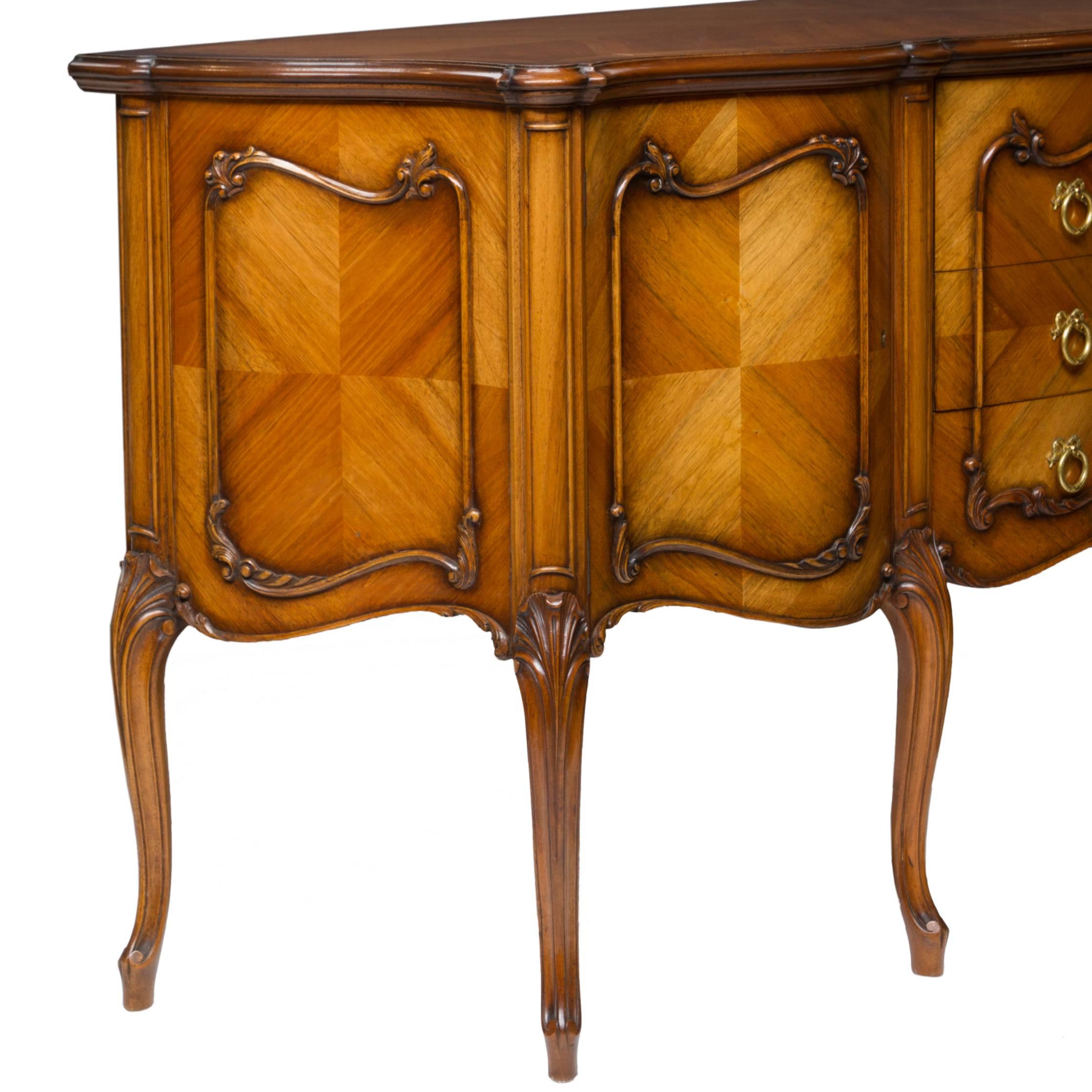 A very clean English made (signed Maples) sideboard. French Provincial in style. Just a well made and functional sideboard. French polished. Quality ormolu pulls. Made of walnut and beautiful cuts of walnut bookmatched veneers, circa 1900s-1920s.