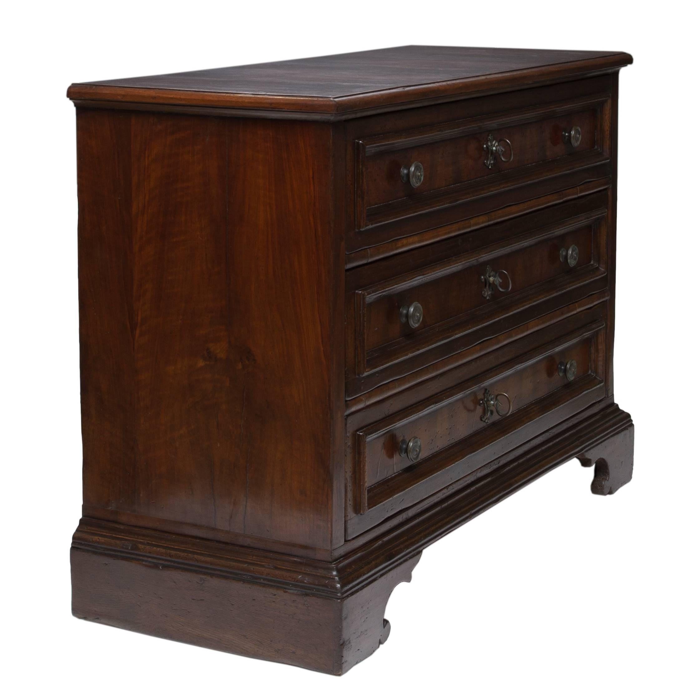 A superb Tuscan walnut commode with iron handles and escutcheons. Thick shaped moldings leading to cuts of figured walnut veneers. Wonderful condition and patina. Clean, circa 1870.