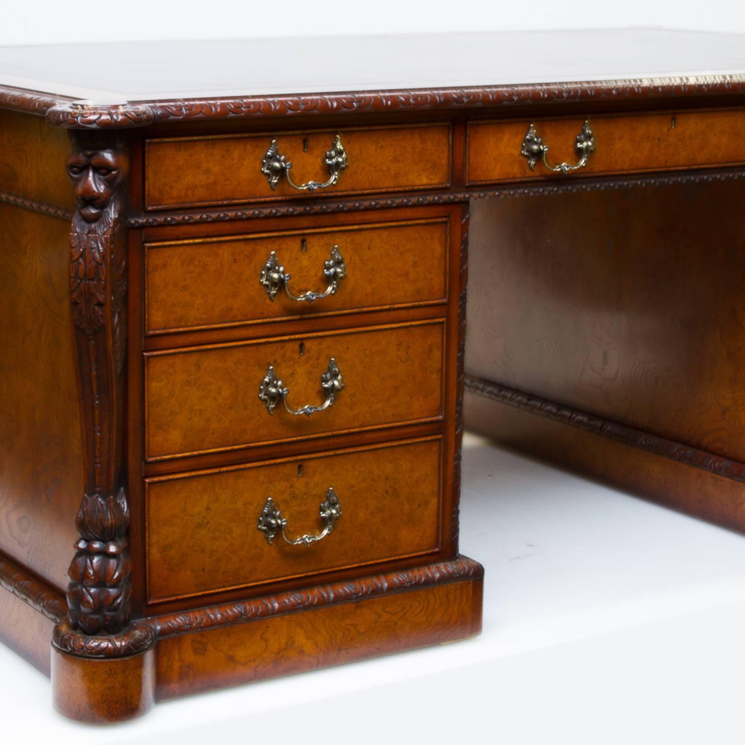 An English bench-made Chippendale partner's desk with leather top. This piece was custom-made from mahogany and Burl pollard oak. It has beautiful Chippendale hardware. One side of the desk is functional with drawers and the other side has drawers