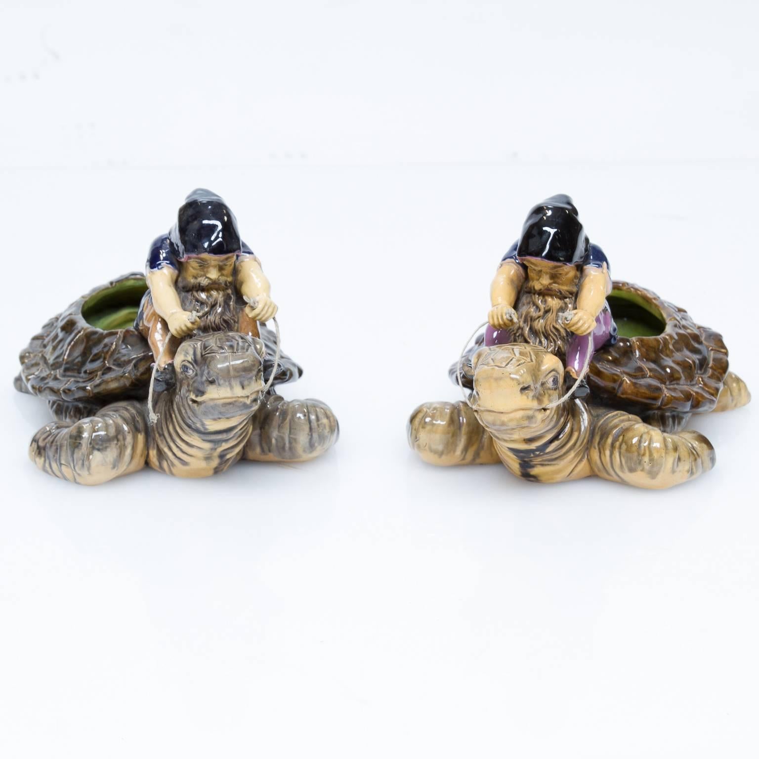 Vintage Majolica Goblin's riding a turtle.
This pair are not matching per say but to put two together as pair, difficult. Here we have collectable Majolica figures. We have added the string. We left one pulled away to show the removability of the
