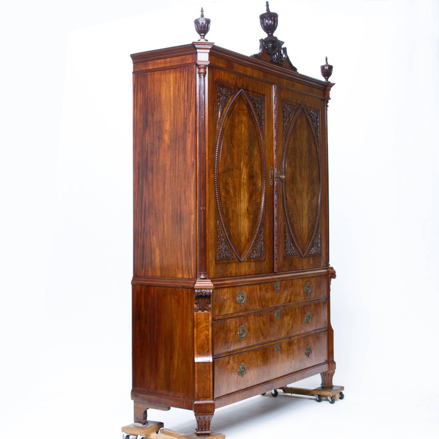 18th century, Dutch, Louis XVI mahogany cabinet

This is an impressive linen press cabinet. It consists of two beautiful doors on the front with raised oval panel doors and four carvings fitted to make a rectangular panel. The molding covering the