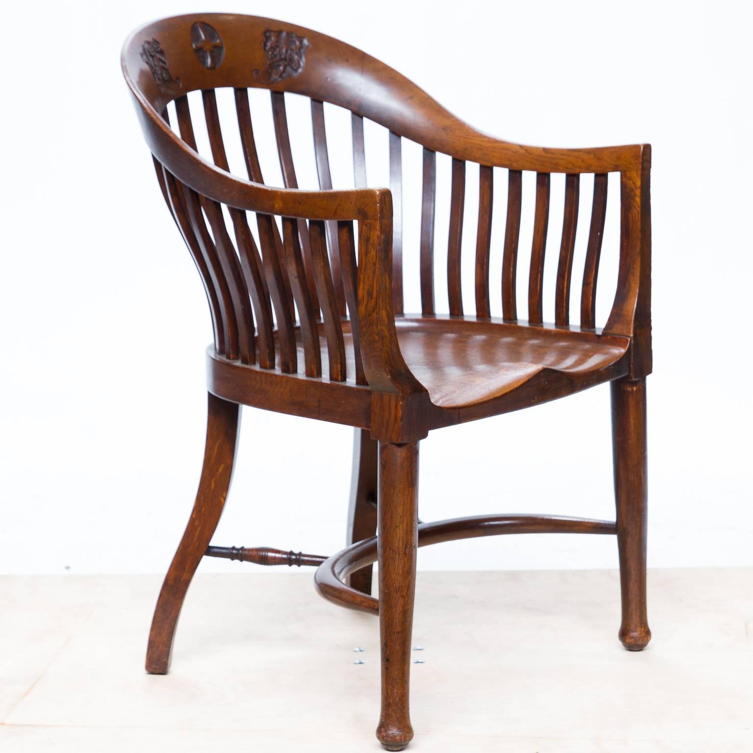 Vintage English barrel back Headmaster's chair. Made from English oak. Very unusual shaped back with individual bent slats. Chiseled shaped seat and a bow shaped stretcher connecting the four legs and for support. The top rail of the back is