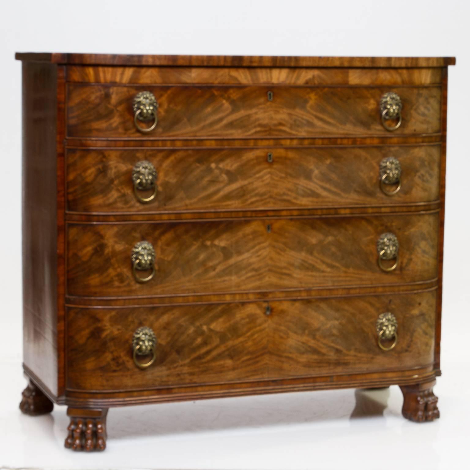 Early 19th century Scottish mahogany chest of drawers with a D-end shape. This meaning looking at the chest from side top view it has a look of the letter D. 
This is chest is from the Regency period or George IV. There are four highly figured