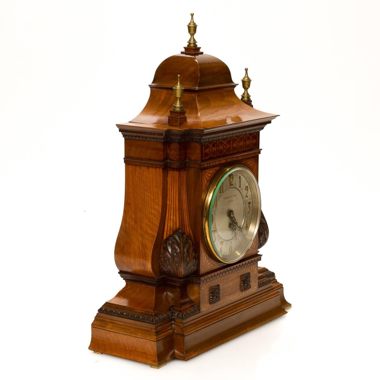 A large English inlaid and carved case mantle clock with a fusée movement. Signed 
