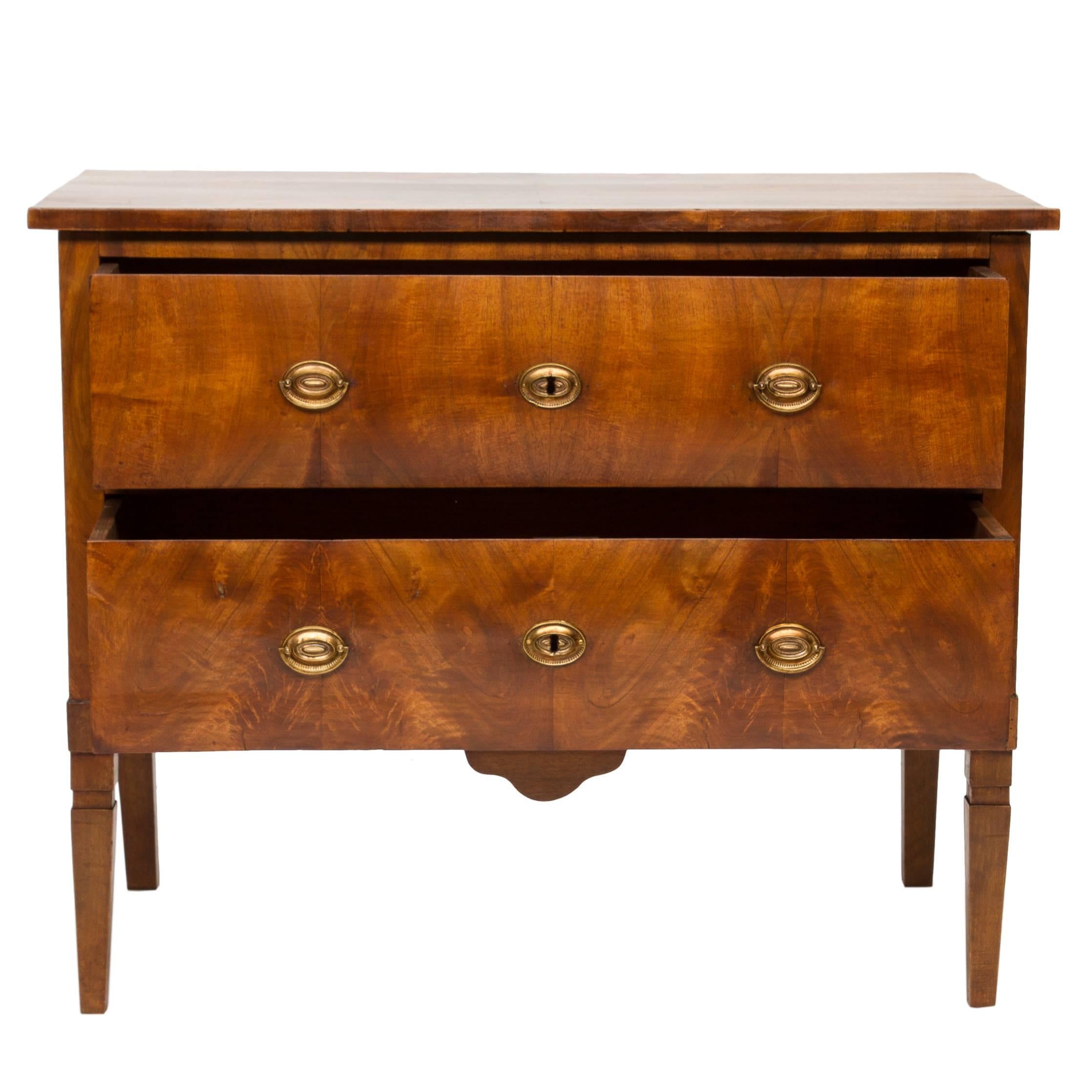 19th century Swedish walnut chest of drawers with brass oval pulls. This piece has had the legs added in a compatible style and been polished. Case is made of pine that has been veneered with thick cuts of walnut. Very nice chest.