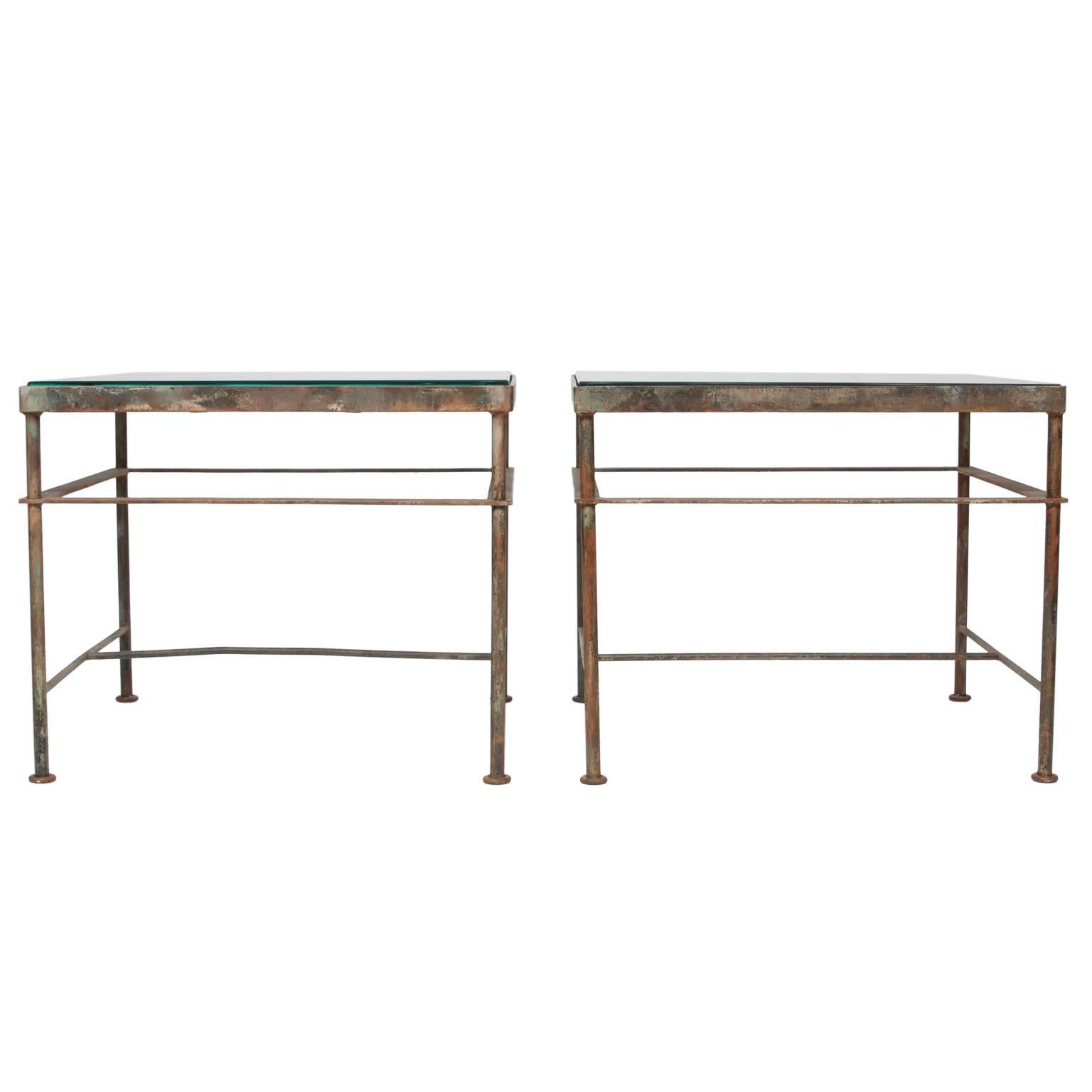 A fine pair of iron side tables with glass top. The scroll tops are balcony fronts from France and made into side tables by welding a heavy gauge iron frame with stretchers. The glass has a slight bevel fitting snuggly into the frame (well measured,