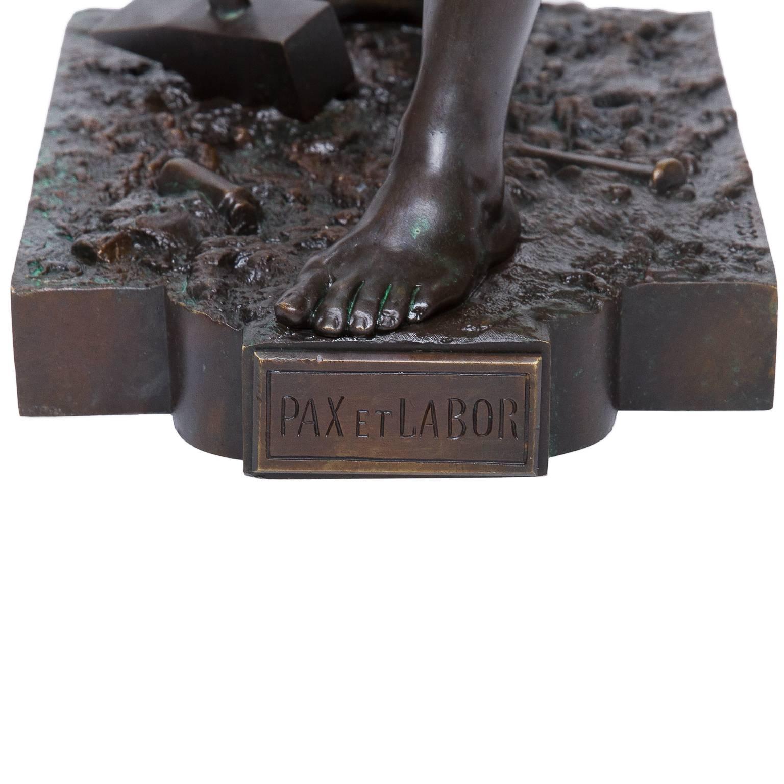 Bronze figure of a worker, Pax et Labor, the classical figure standing holding a sledgehammer, its head resting on the ground, on naturalistic bow fronted base with title. French Bronze Statue, Pax et Labor by E. L. Picault (1833-1915). This is an