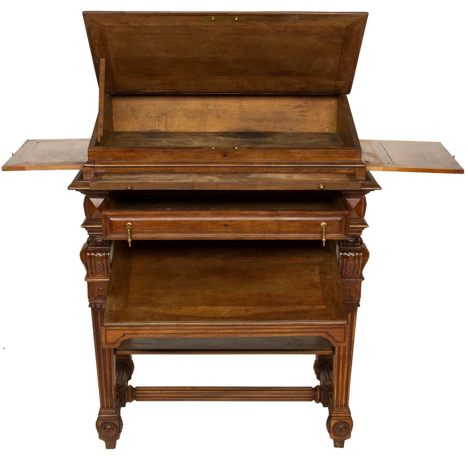 French walnut stand up writing desk in the Renaissance style. The top rest upon the base and is slanted with a lift surface revealing storage. In between the writing slope and base, is a pull-out writing surface and two pull-out candle slide on the