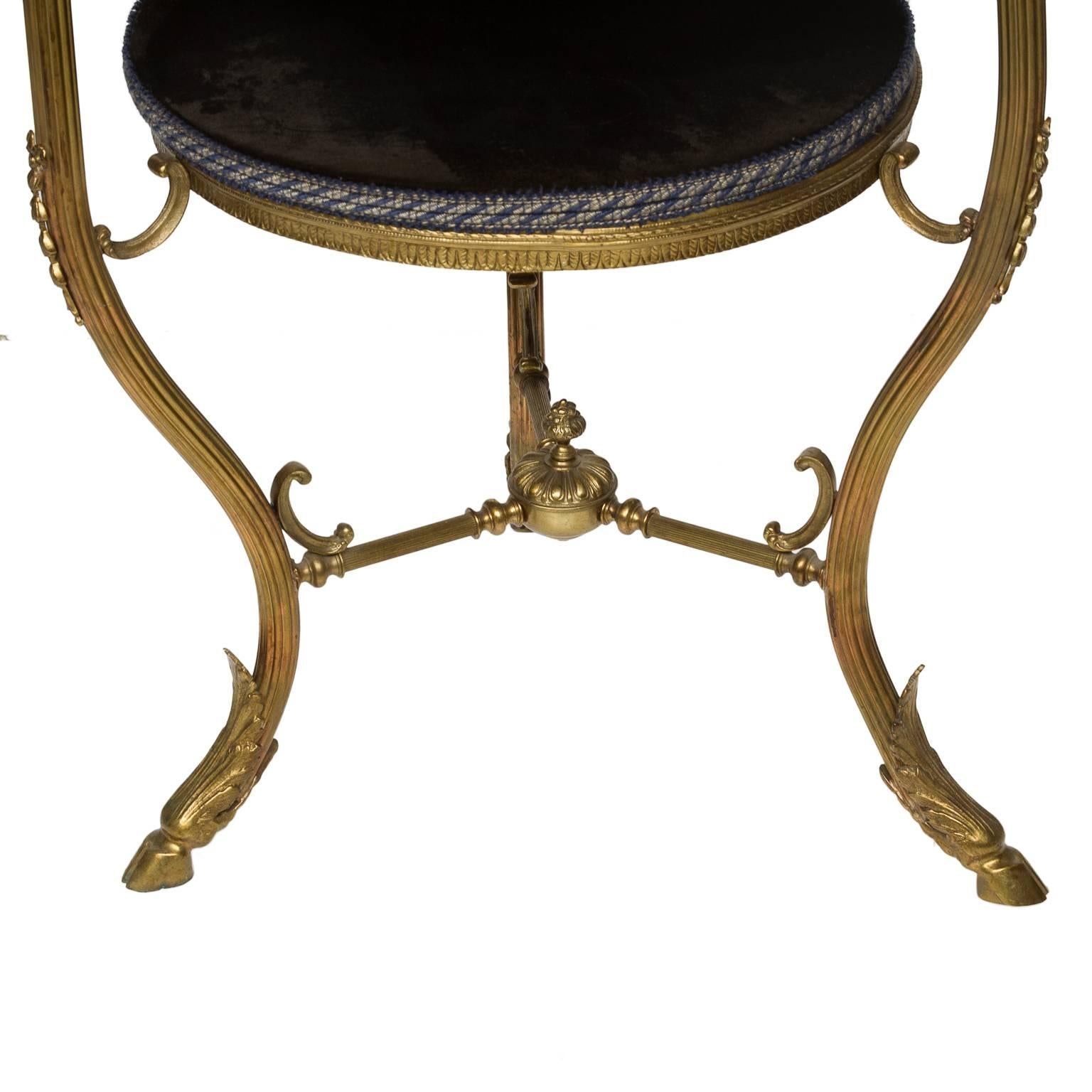 These Italian two-tiered side tables have four fitted navy Italian velvet platforms. The elegant reeded curved legs end with capped acanthus leaf and hoofed feet. The finely reeded stretcher is centered with a finial. The sides tables are enhanced