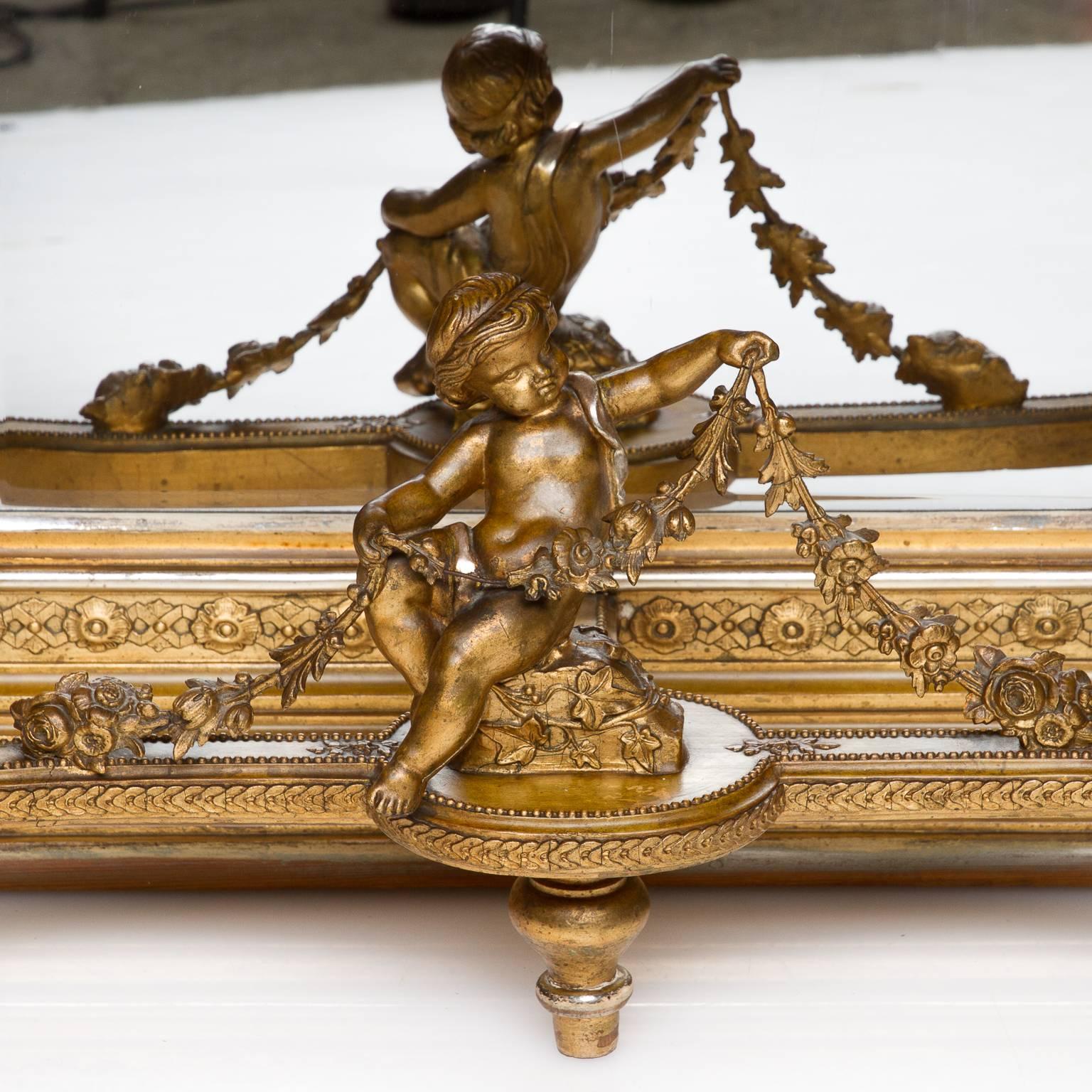A fine example of a Louis XVI polychrome marble-top console with mirror back. An ornate stretcher centered with a carved wood putti with swags of garland draping over the lap. There is a beveled mirror framed in the back. Very fine detailed legs and