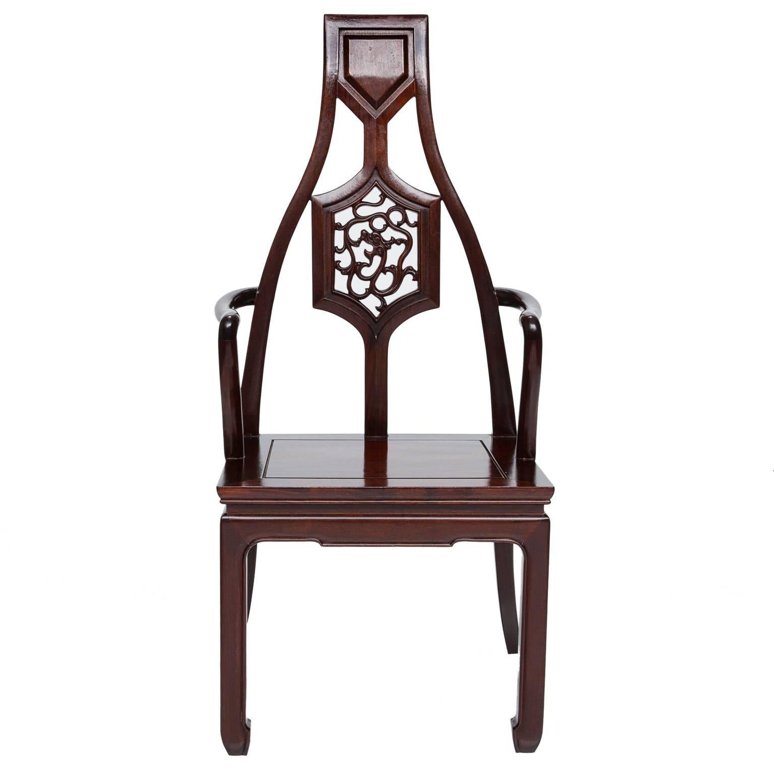 A set of eight dining chairs. Two are taller and six sides are the same size. These are handmade from solid mahogany. Exceptional detail and shape to each chair. Set into the splat of the backs are carved dragons (fine detail). Each seat is cut to