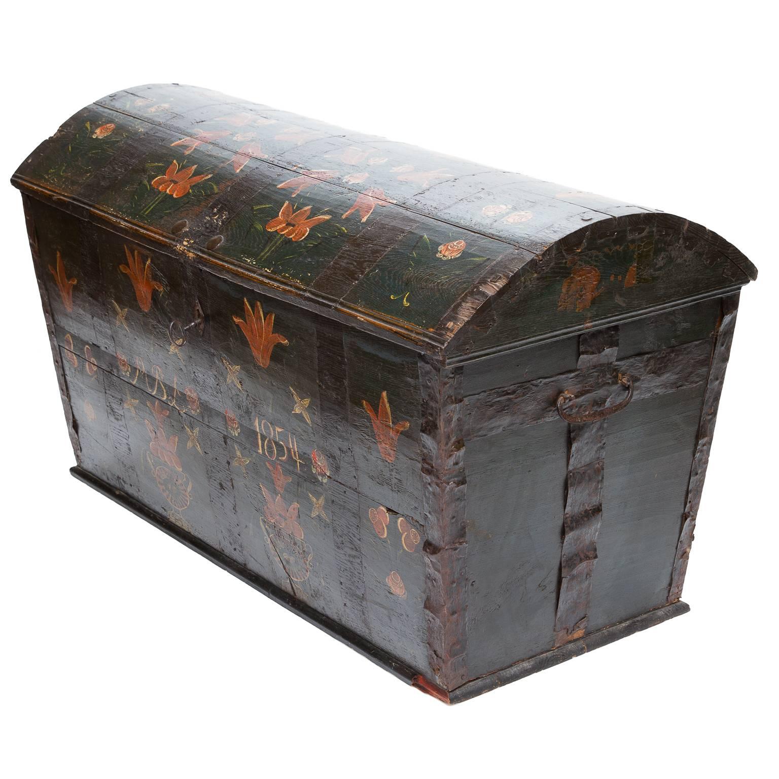 This wonderful Swedish painted dome top chest is perhaps my favorite piece in the shop at the moment. The richness of the finish, the whimsy of the hand-painted tulips on the top and front, the fashioned iron handles, the metal binding, the interior